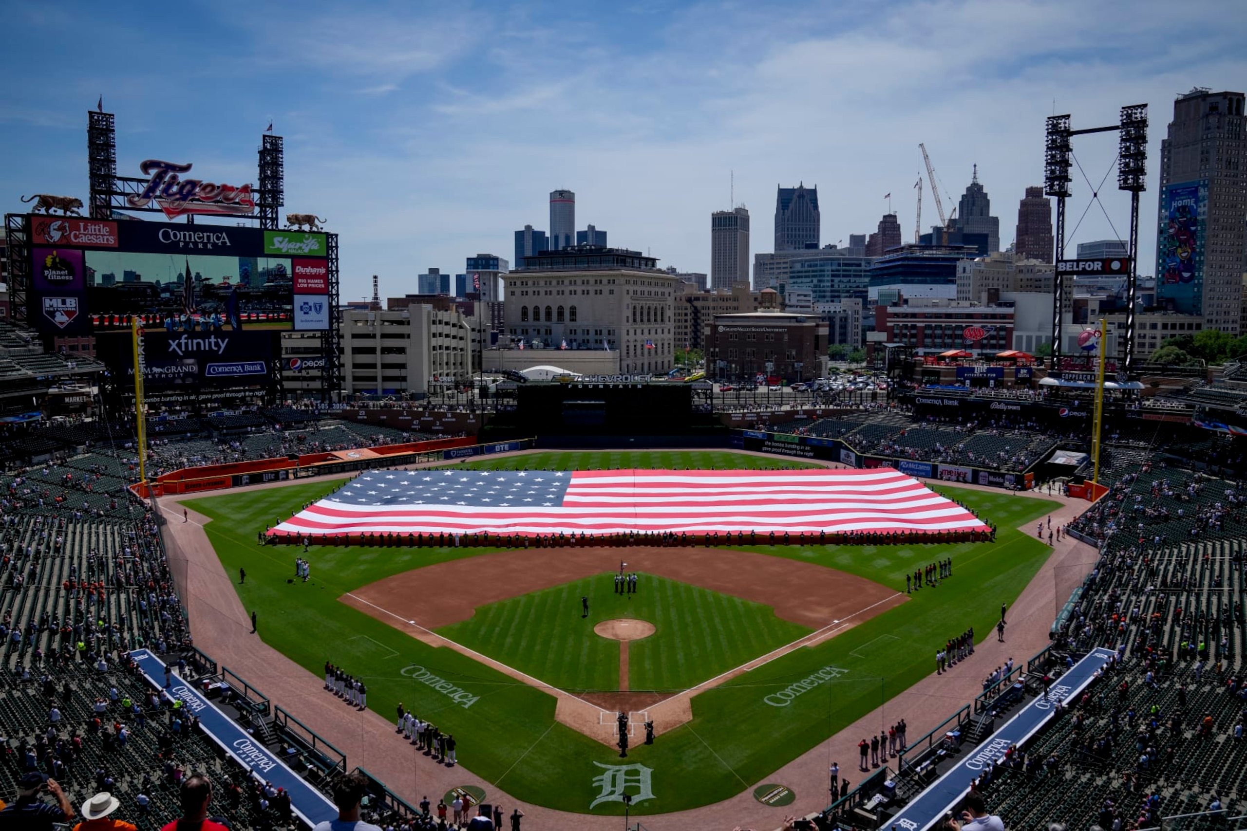 DETROIT, MICHIGAN - JULY 04: The American flag is presented during the national anthem before the game between the Detroit Tigers and Cleveland Guardians at Comerica Park on July 04, 2022 in Detroit, Michigan. (Photo by Nic Antaya/Getty Images)