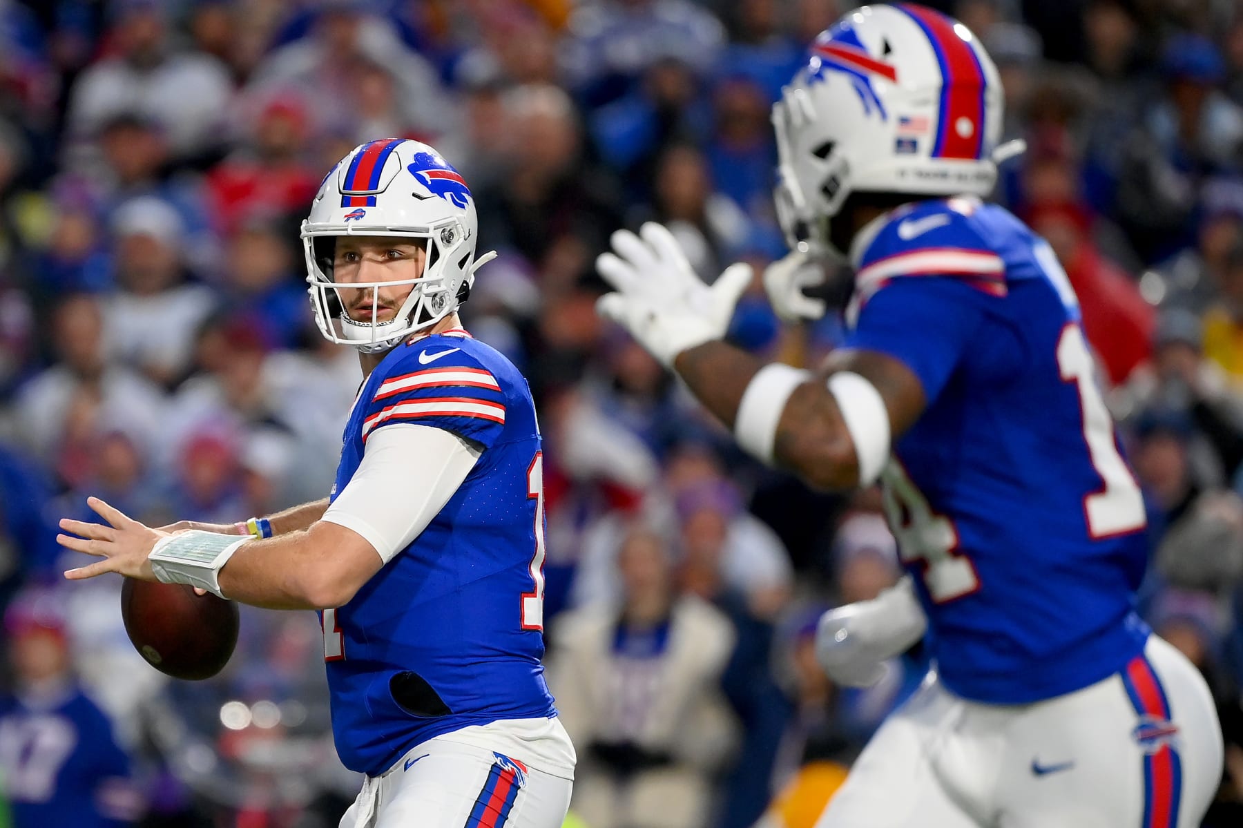 ORCHARD PARK, NEW YORK - DECEMBER 17: Josh Allen #17 of the Buffalo Bills attempts a pass while Stefon Diggs #14 of the Buffalo Bills runs a route during the first quarter against the Dallas Cowboys at Highmark Stadium on December 17, 2023 in Orchard Park, New York. (Photo by Rich Barnes/Getty Images)