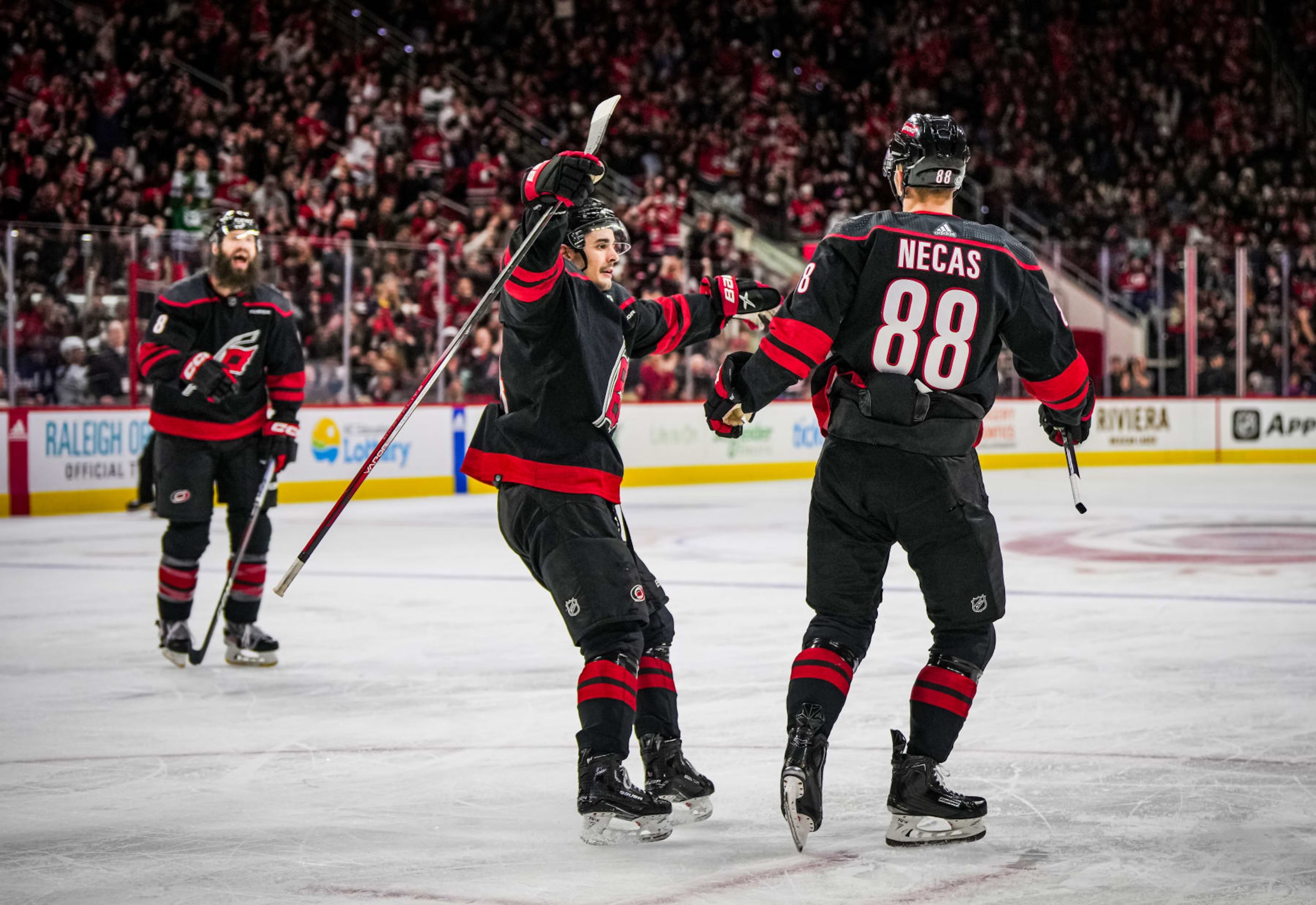 RALEIGH, NORTH CAROLINA - JANUARY 27: Martin Necas #88 of the Carolina Hurricanes celebrates with teammates after a goal during the second period against the Arizona Coyotes at PNC Arena on January 27, 2024 in Raleigh, North Carolina. (Photo by Josh Lavallee/NHLI via Getty Images)