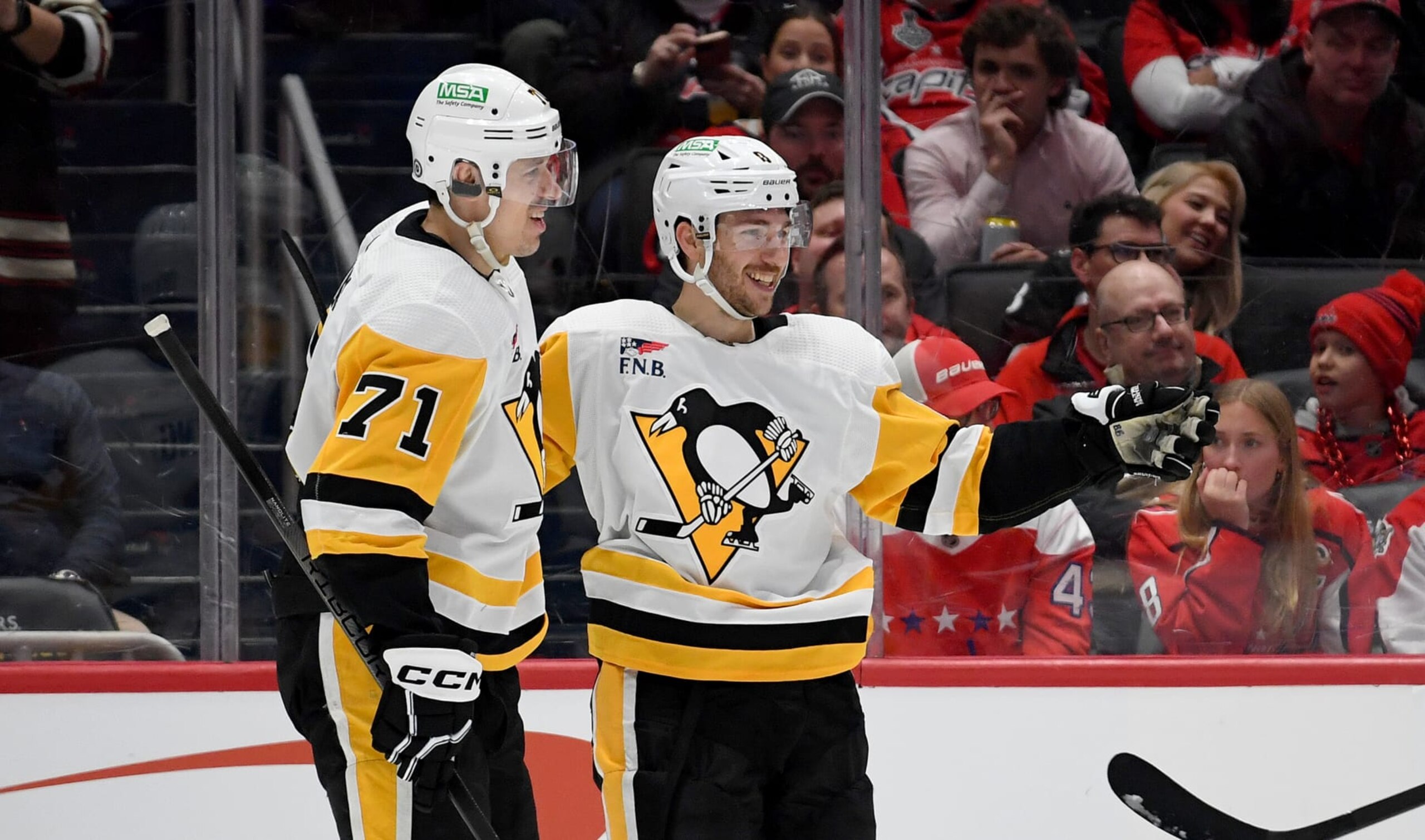 WASHINGTON, DC - APRIL 04: Penguins center Evgeni Geno Malkin (71) and left wing Michael Bunting (8) celebrate after Bunting's second period goal during the Pittsburgh Penguins versus Washington Capitals National Hockey League game on April 4, 2024 at Capital One Arena in Washington, D.C.. (Photo by Randy Litzinger/Icon Sportswire via Getty Images)