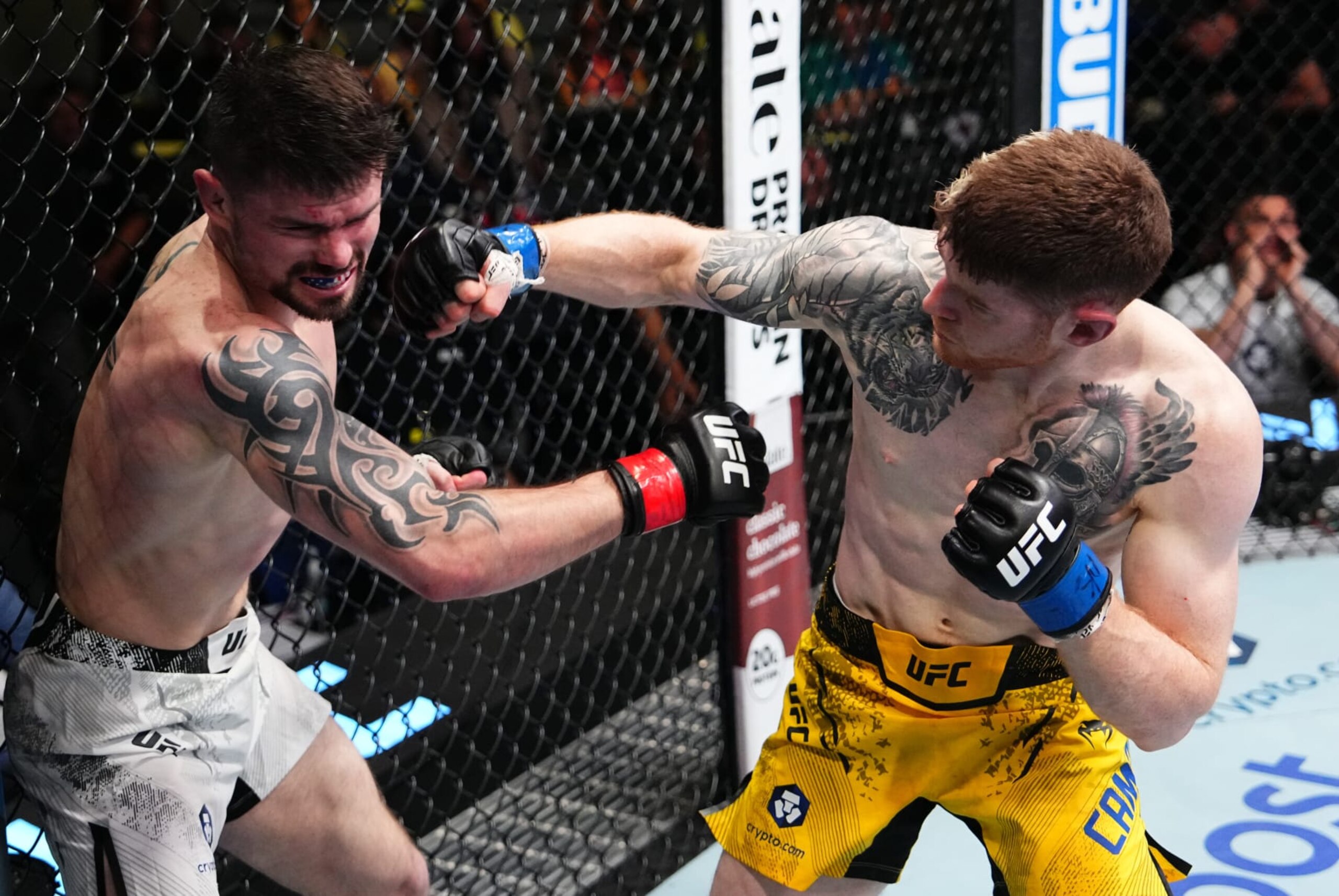 LAS VEGAS, NEVADA - APRIL 06: (R-L) Charlie Campbell punches Trevor Peek in a lightweight fight during the UFC Fight Night event at UFC APEX on April 06, 2024 in Las Vegas, Nevada. (Photo by Jeff Bottari/Zuffa LLC via Getty Images)