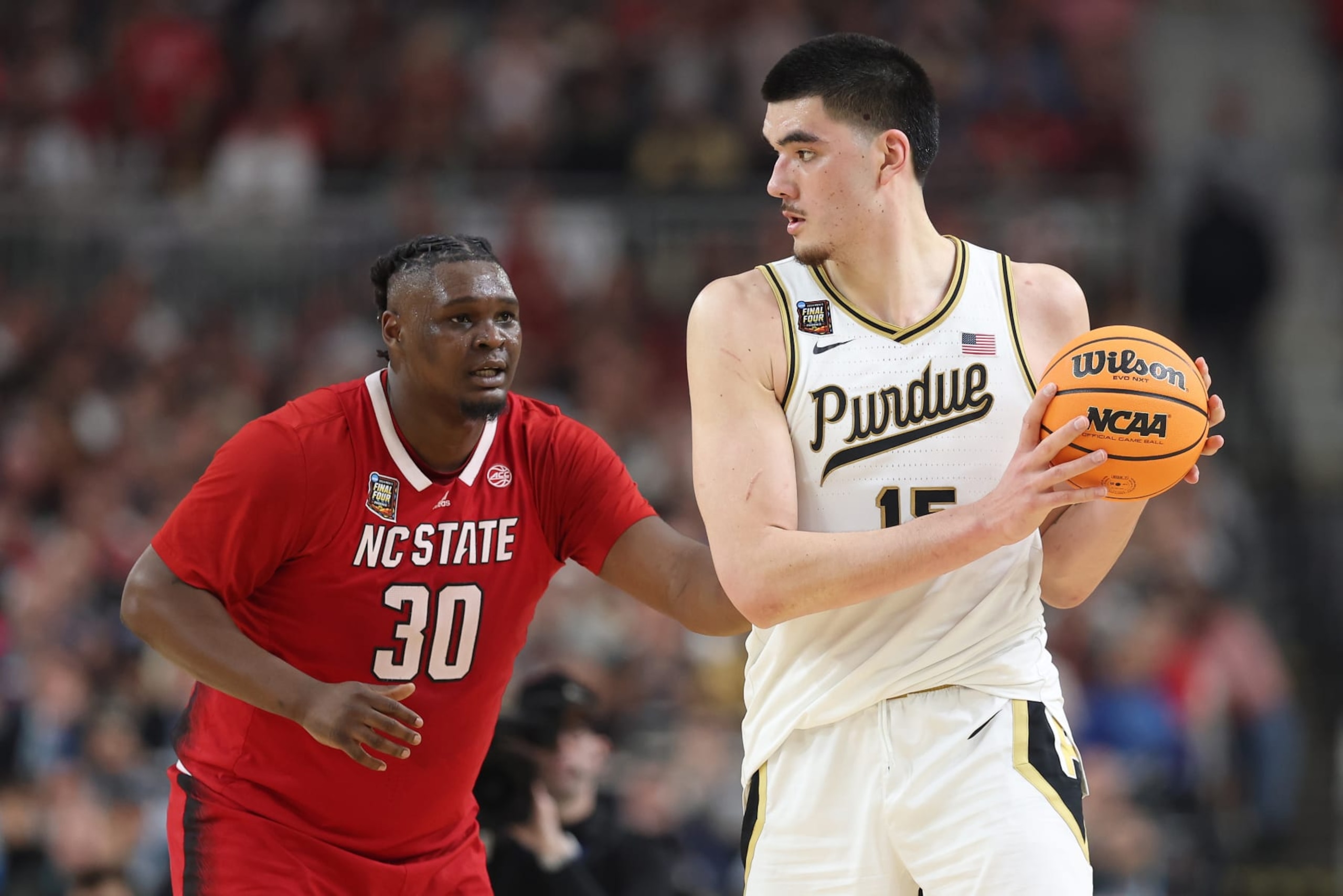 GLENDALE, ARIZONA - APRIL 06: Zach Edey #15 of the Purdue Boilermakers handles the ball while being guarded by DJ Burns Jr. #30 of the North Carolina State Wolfpack in the second half in the NCAA Men's Basketball Tournament Final Four semifinal game at State Farm Stadium on April 06, 2024 in Glendale, Arizona. (Photo by Christian Petersen/Getty Images) GLENDALE, ARIZONA - APRIL 06: Zach Edey #15 of the Purdue Boilermakers handles the ball while being guarded by DJ Burns Jr. #30 of the North Carolina State Wolfpack in the second half in the NCAA Men's Basketball Tournament Final Four semifinal game at State Farm Stadium on April 06, 2024 in Glendale, Arizona. (Photo by Christian Petersen/Getty Images)