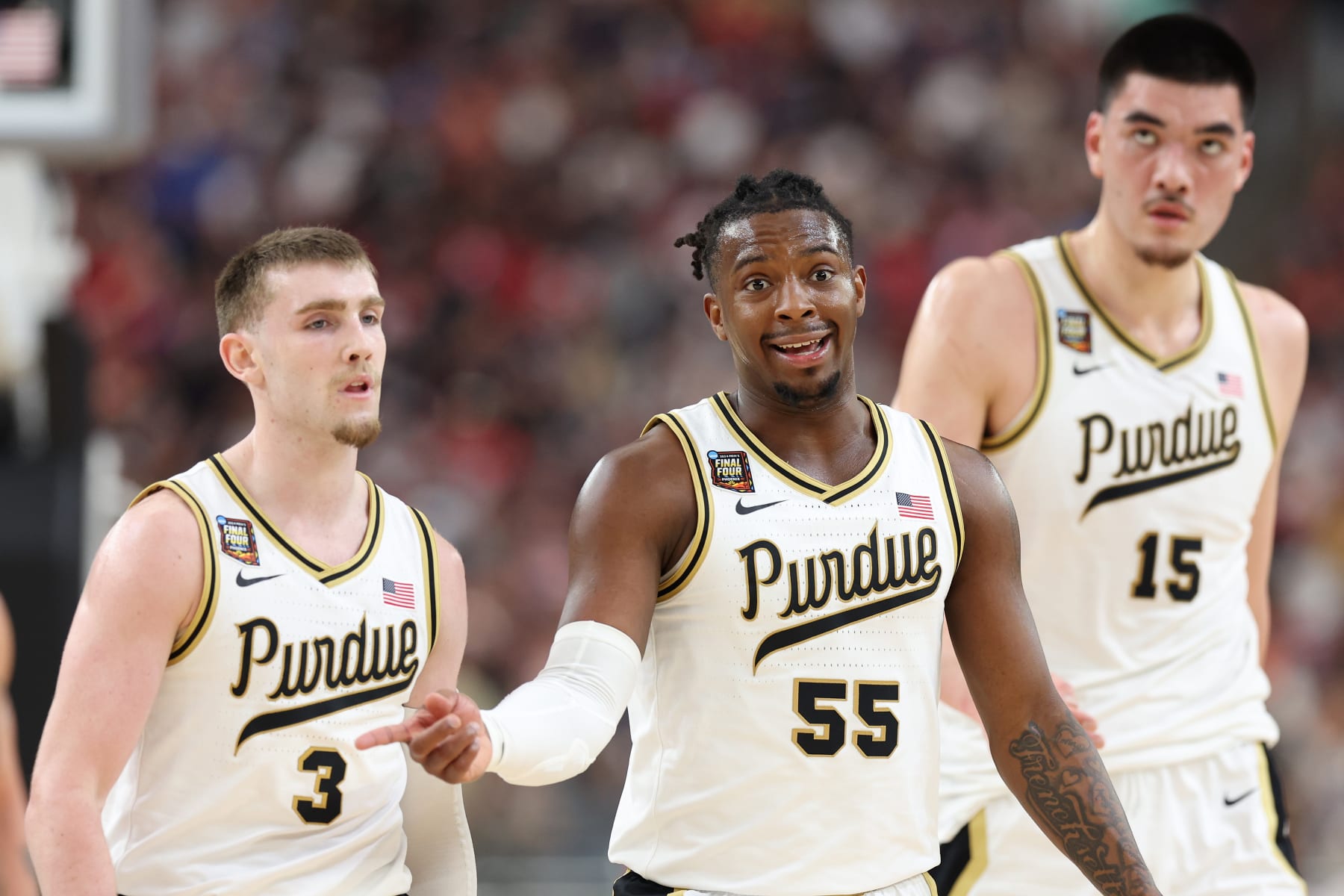 GLENDALE, ARIZONA - APRIL 06: Braden Smith #3, Lance Jones #55, and Zach Edey #15 of the Purdue Boilermakers walk across the court in the first half against the North Carolina State Wolfpack in the NCAA Men's Basketball Tournament Final Four semifinal game at State Farm Stadium on April 06, 2024 in Glendale, Arizona. (Photo by Jamie Squire/Getty Images)