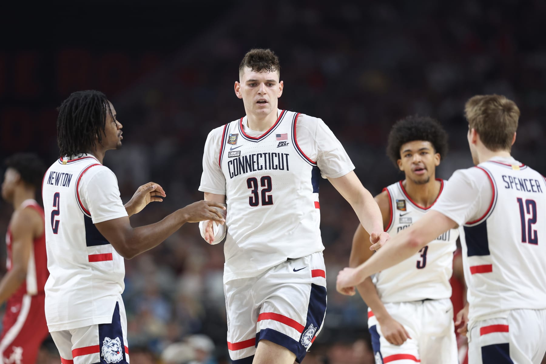 GLENDALE, ARIZONA - APRIL 06: Donovan Clingan #32 of the Connecticut Huskies celebrates with teammates in the first half against the Alabama Crimson Tide in the NCAA Men's Basketball Tournament Final Four semifinal game at State Farm Stadium on April 06, 2024 in Glendale, Arizona. (Photo by Christian Petersen/Getty Images)
