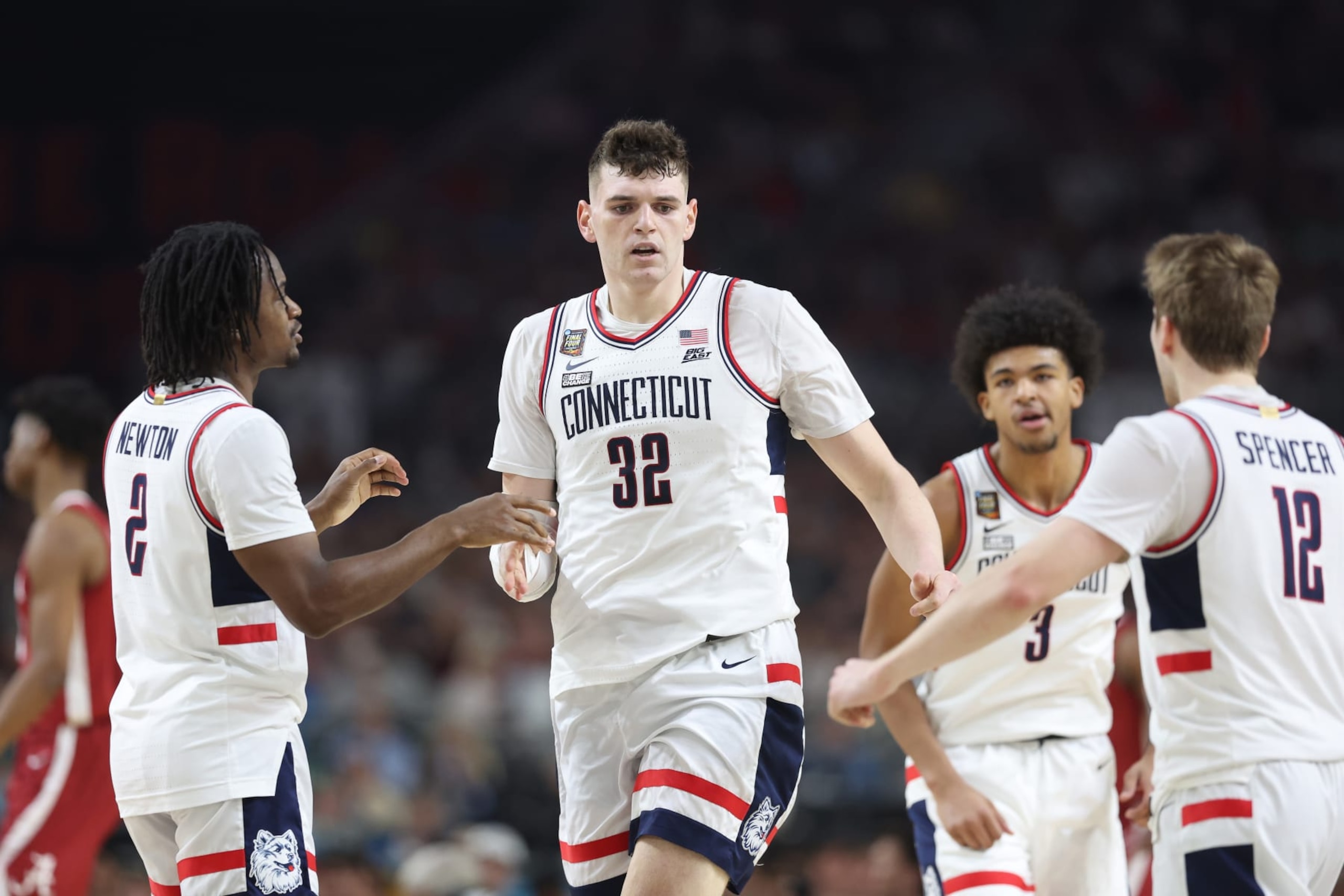 GLENDALE, ARIZONA - APRIL 06: Donovan Clingan #32 of the Connecticut Huskies celebrates with teammates in the first half against the Alabama Crimson Tide in the NCAA Men's Basketball Tournament Final Four semifinal game at State Farm Stadium on April 06, 2024 in Glendale, Arizona. (Photo by Christian Petersen/Getty Images)