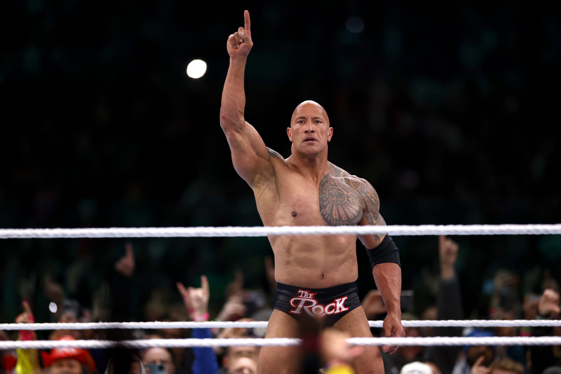 PHILADELPHIA, PENNSYLVANIA - APRIL 06: Dwayne "The Rock" Johnson reacts during a tag team fight against Cody Rhodes and Seth "Freakin" Rollins during Night One of WrestleMania 40 at Lincoln Financial Field on April 06, 2024 in Philadelphia, Pennsylvania.  (Photo by Tim Nwachukwu/Getty Images)