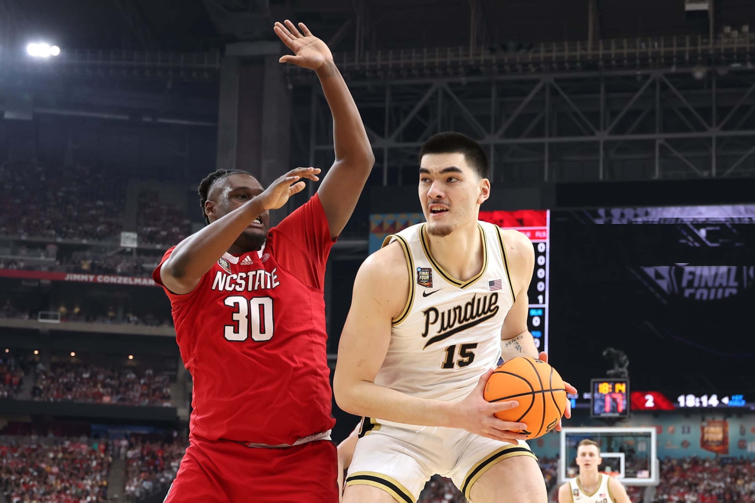 GLENDALE, ARIZONA - APRIL 06: Zach Edey #15 of the Purdue Boilermakers handles the ball while being guarded by DJ Burns Jr. #30 of the North Carolina State Wolfpack in the first half in the NCAA Men's Basketball Tournament Final Four semifinal game at State Farm Stadium on April 06, 2024 in Glendale, Arizona. (Photo by Christian Petersen/Getty Images)