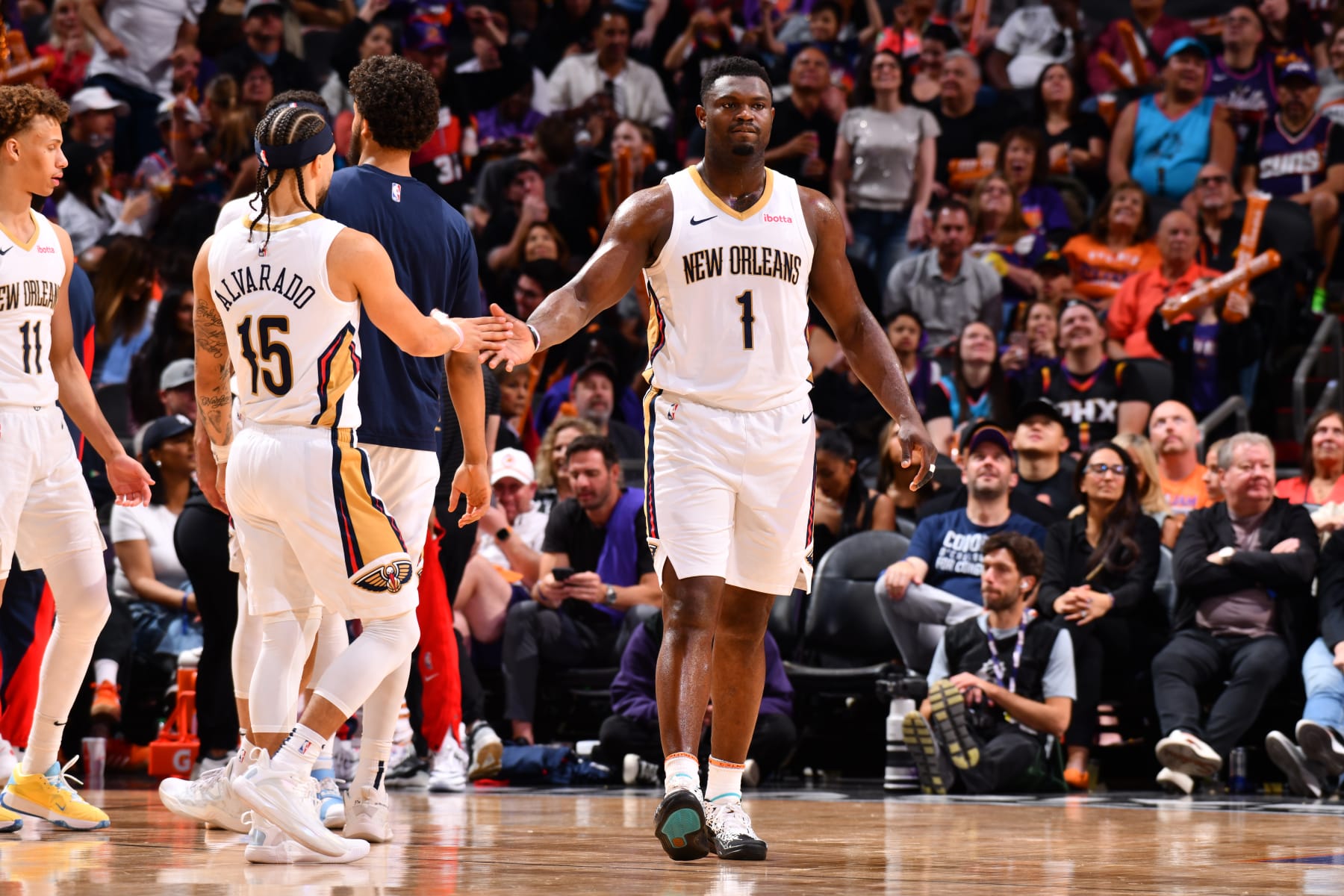 PHOENIX, AZ - APRIL 7: Jose Alvarado #15 of the New Orleans Pelicans and Zion Williamson #1 of the New Orleans Pelicans high five during the game against the Phoenix Suns on April 7, 2024 at Footprint Center in Phoenix, Arizona. NOTE TO USER: User expressly acknowledges and agrees that, by downloading and or using this photograph, user is consenting to the terms and conditions of the Getty Images License Agreement. Mandatory Copyright Notice: Copyright 2024 NBAE (Photo by Barry Gossage/NBAE via Getty Images)