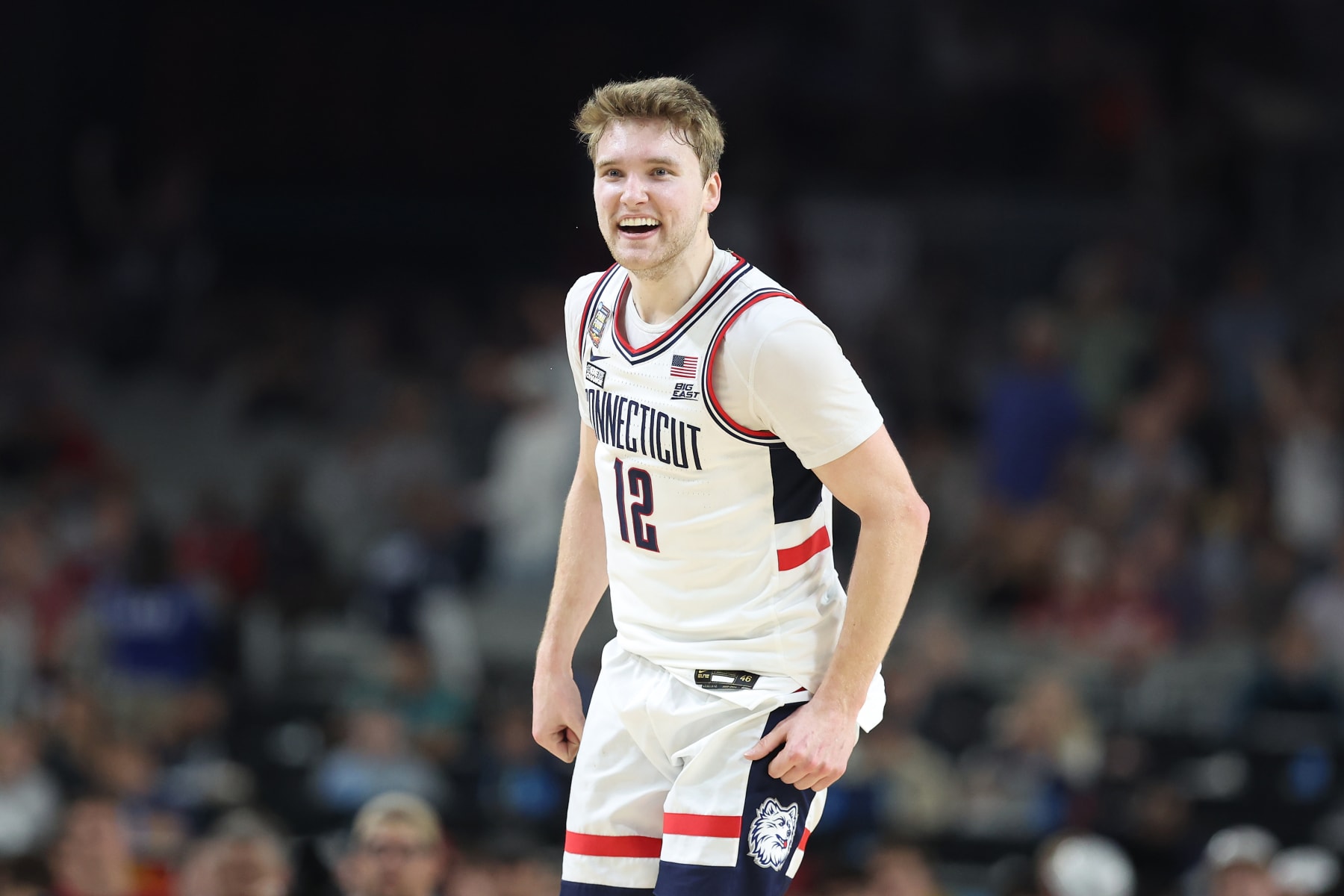GLENDALE, ARIZONA - APRIL 06: Cam Spencer #12 of the Connecticut Huskies celebrates after making a shot in the second half against the Alabama Crimson Tide in the NCAA Men's Basketball Tournament Final Four semifinal game at State Farm Stadium on April 06, 2024 in Glendale, Arizona. (Photo by Christian Petersen/Getty Images)