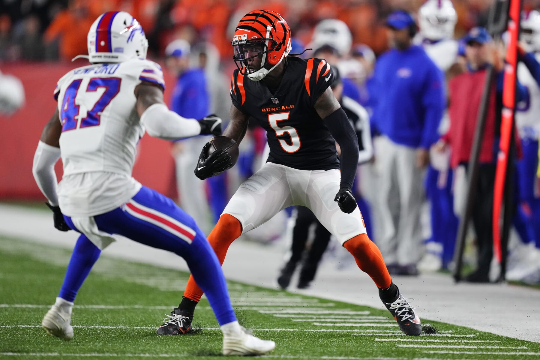 CINCINNATI, OHIO - NOVEMBER 05:  Tee Higgins #5 of the Cincinnati Bengals carries the ball against Christian Benford #47 of the Buffalo Bills during the first quarter at Paycor Stadium on November 05, 2023 in Cincinnati, Ohio. (Photo by Dylan Buell/Getty Images)