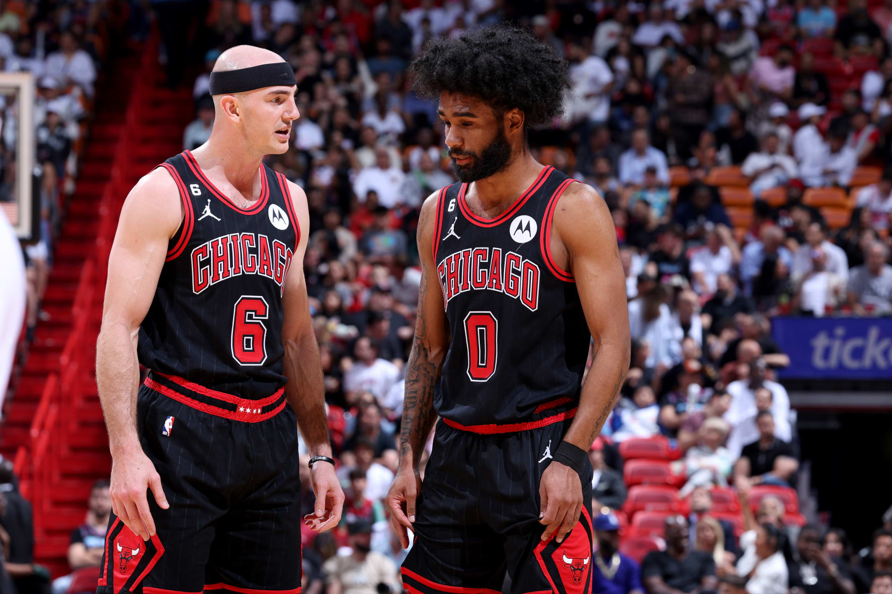 MIAMI, FL - APRIL 14: Alex Caruso #6 and Coby White #0 of the Chicago Bulls talk on the court during the game against the Miami Heat During the 2023 Play-in Tournament on April 14, 2023 at Kaseya Center in Miami, Florida. NOTE TO USER: User expressly acknowledges and agrees that, by downloading and or using this photograph, User is consenting to the terms and conditions of the Getty Images License Agreement. Mandatory Copyright Notice: Copyright 2023 NBAE (Photo by Jeff Haynes/NBAE via Getty Images)