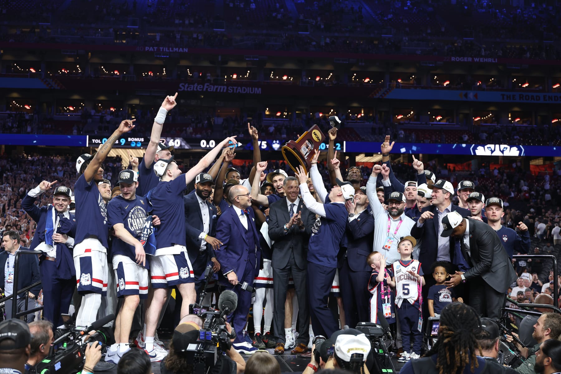GLENDALE, ARIZONA - APRIL 08: The Connecticut Huskies celebrate with the trophy after beating the Purdue Boilermakers 75-60 to win the NCAA Men's Basketball Tournament National Championship game at State Farm Stadium on April 08, 2024 in Glendale, Arizona. (Photo by Christian Petersen/Getty Images)