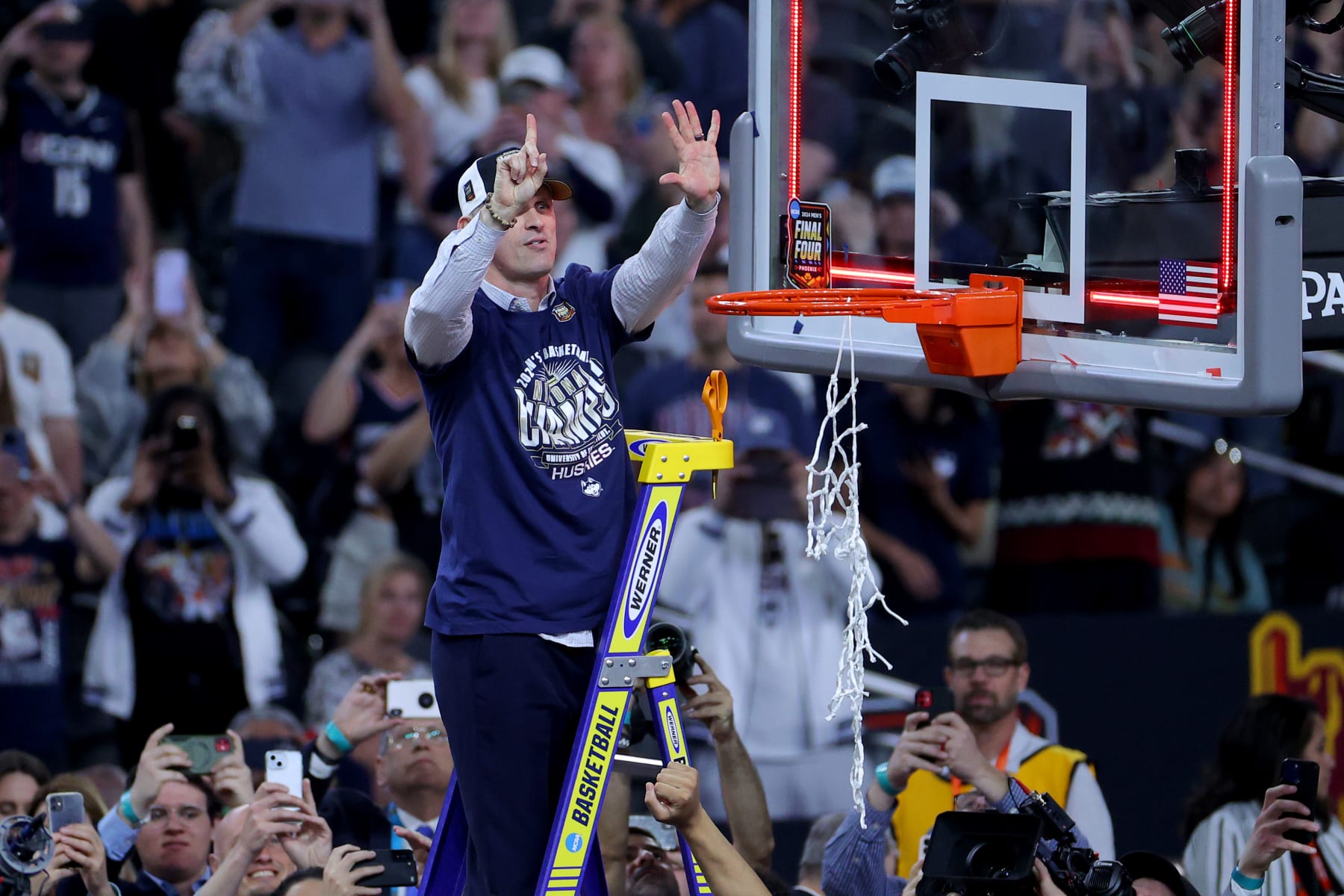 Dan Hurley cuts down the nets after his second, UConn's sixth national championship in men's college basketball.