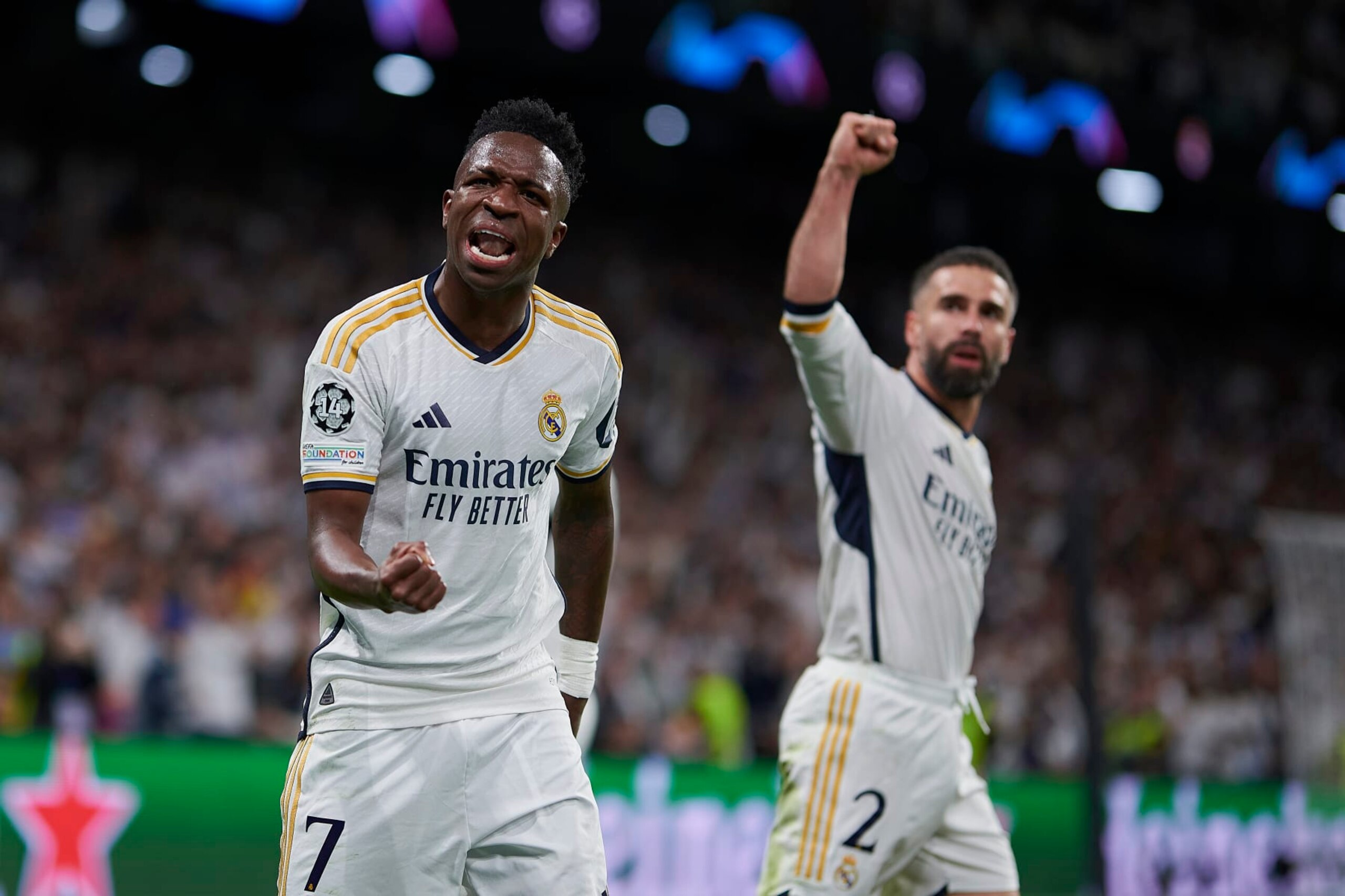 MADRID, SPAIN - APRIL 9: Vinicius Júnior and Dani Caravajal of Real Madrid CF celebrates a goal during the Quarter-final First Leg - UEFA Champions League  match between Real Madrid CF and Manchester City at Estadio Santiago Bernabeu on April 9, 2024 in Madrid, Spain. (Photo by Pablo Morano/BSR Agency/Getty Images)