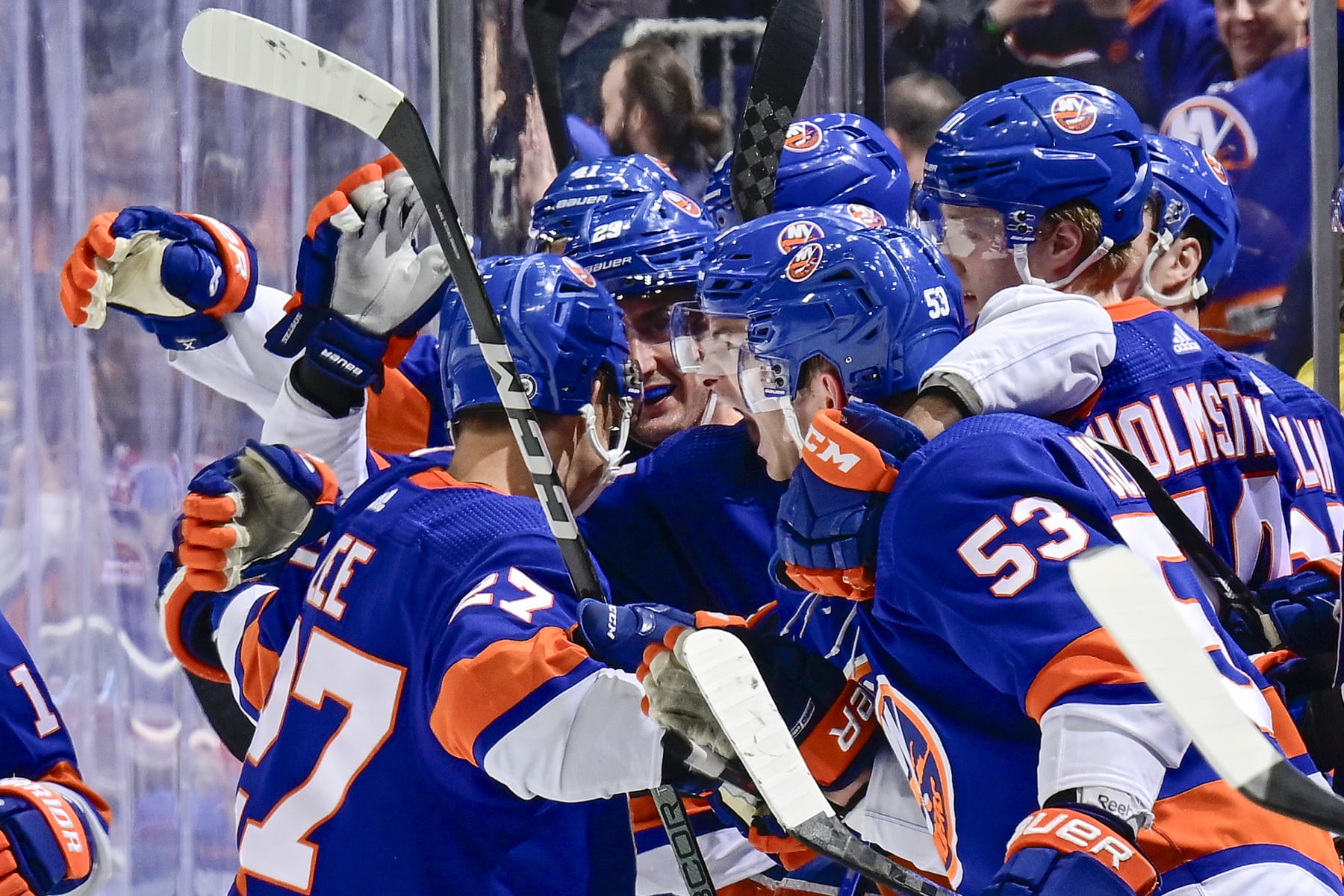ELMONT, NEW YORK - APRIL 09:  Anders Lee #27 of the New York Islanders is congratulated by his teammates after scoring an empty-net goal against the New York Rangers during the third period at UBS Arena on April 09, 2024 in Elmont, New York. (Photo by Steven Ryan/NHLI via Getty Images)