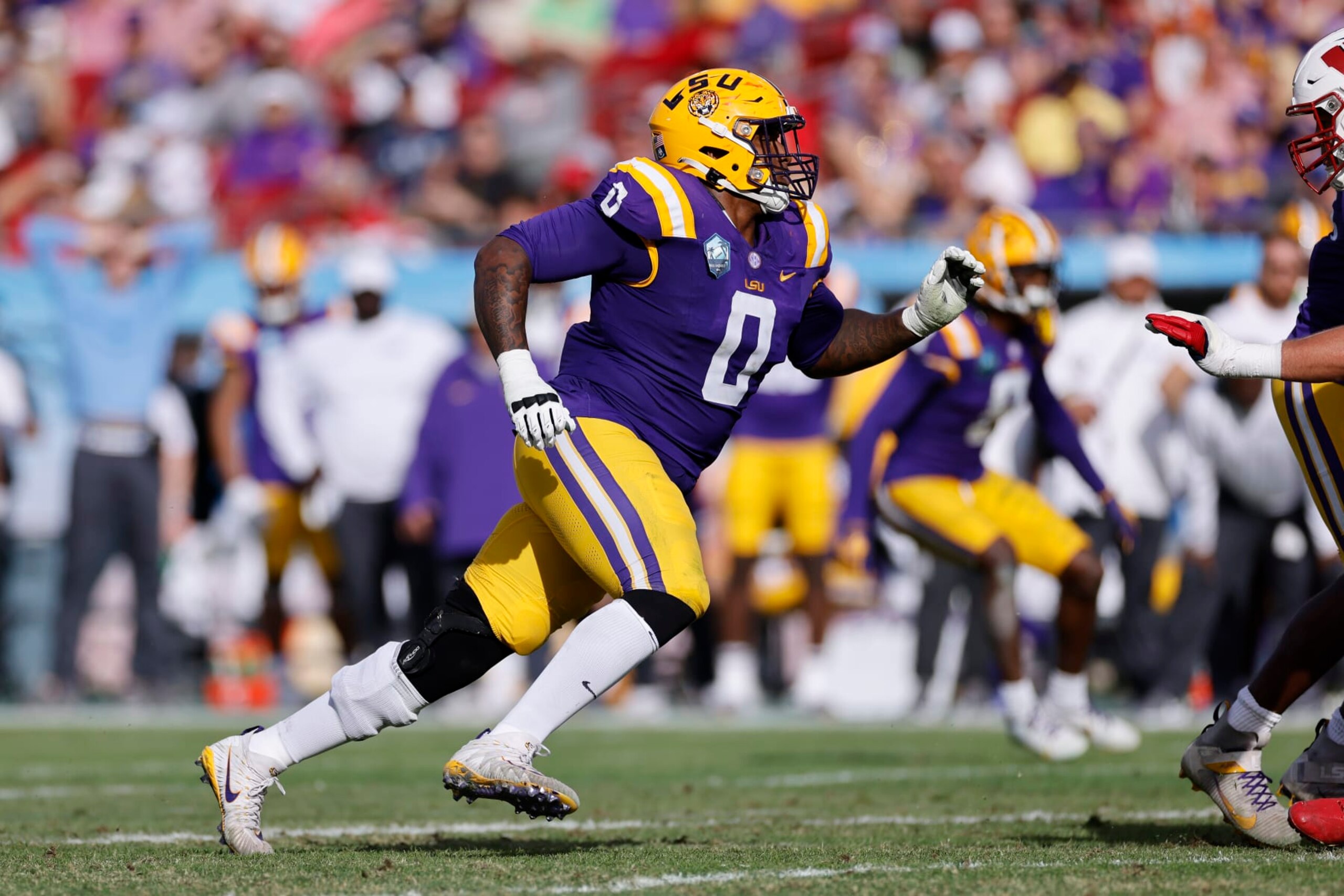 TAMPA, FL - JANUARY 01: LSU Tigers defensive tackle Maason Smith (0) rushes on defense during the ReliaQuest Bowl against the Wisconsin Badgers on January 1, 2024 at Raymond James Stadium in Tampa, Florida. (Photo by Joe Robbins/Icon Sportswire via Getty Images) TAMPA, FL - JANUARY 01: LSU Tigers defensive tackle Maason Smith (0) rushes on defense during the ReliaQuest Bowl against the Wisconsin Badgers on January 1, 2024 at Raymond James Stadium in Tampa, Florida. (Photo by Joe Robbins/Icon Sportswire via Getty Images)