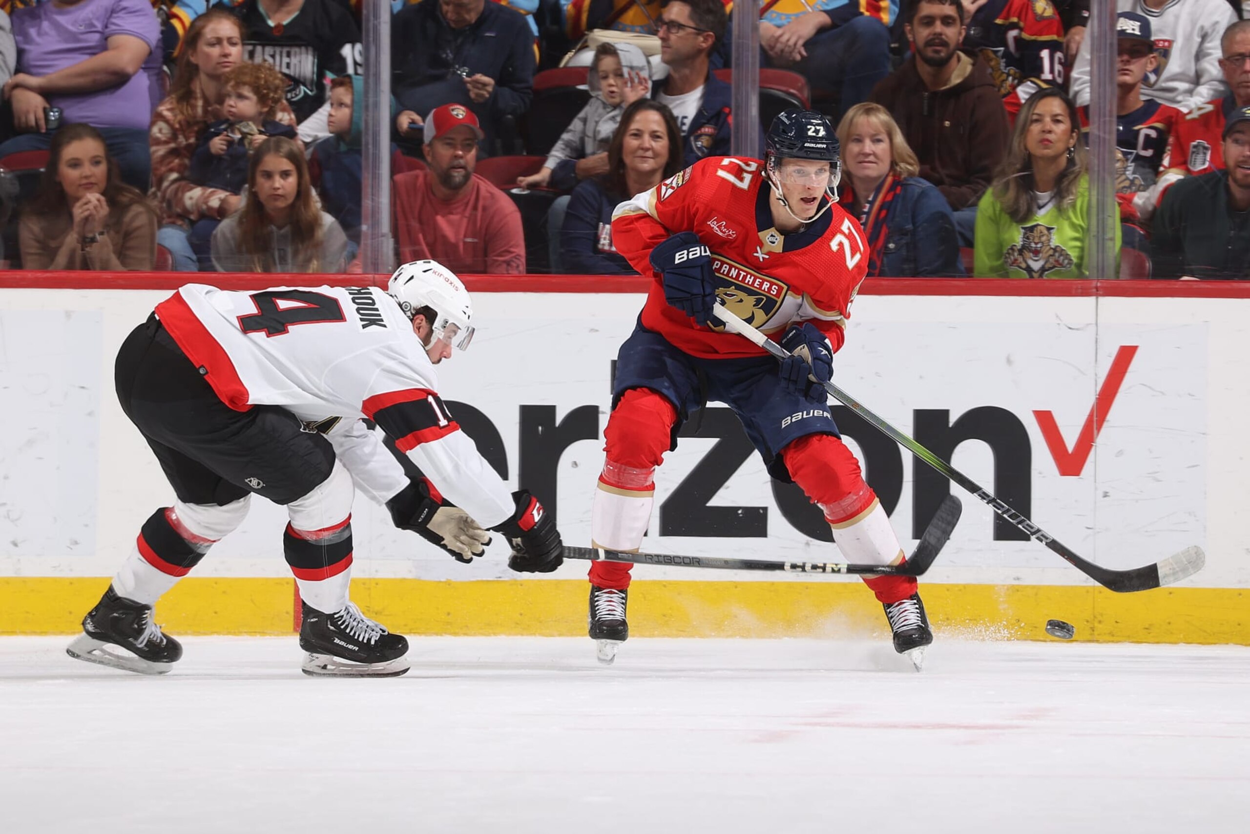 SUNRISE, FL - APRIL 9: Boris Katchouk #14 of the Ottawa Senators defends against Eetu Luostarinen #27 of the Florida Panthers as he passes the puck during first period action at the Amerant Bank Arena on April 9, 2024 in Sunrise, Florida. (Photo by Joel Auerbach/Getty Images)