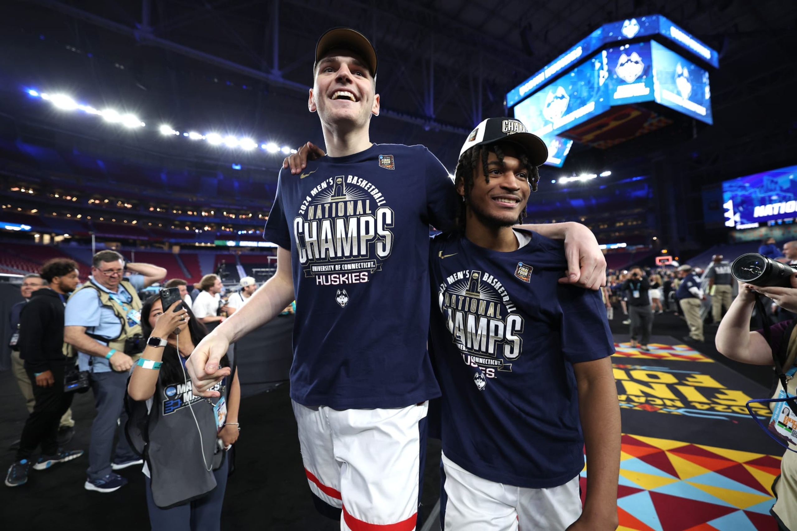 GLENDALE, ARIZONA - APRIL 08: Donovan Clingan #32 and Stephon Castle #5 of the Connecticut Huskies celebrate after beating the Purdue Boilermakers 75-60 to win the NCAA Men's Basketball Tournament National Championship game at State Farm Stadium on April 08, 2024 in Glendale, Arizona. (Photo by Jamie Squire/Getty Images)