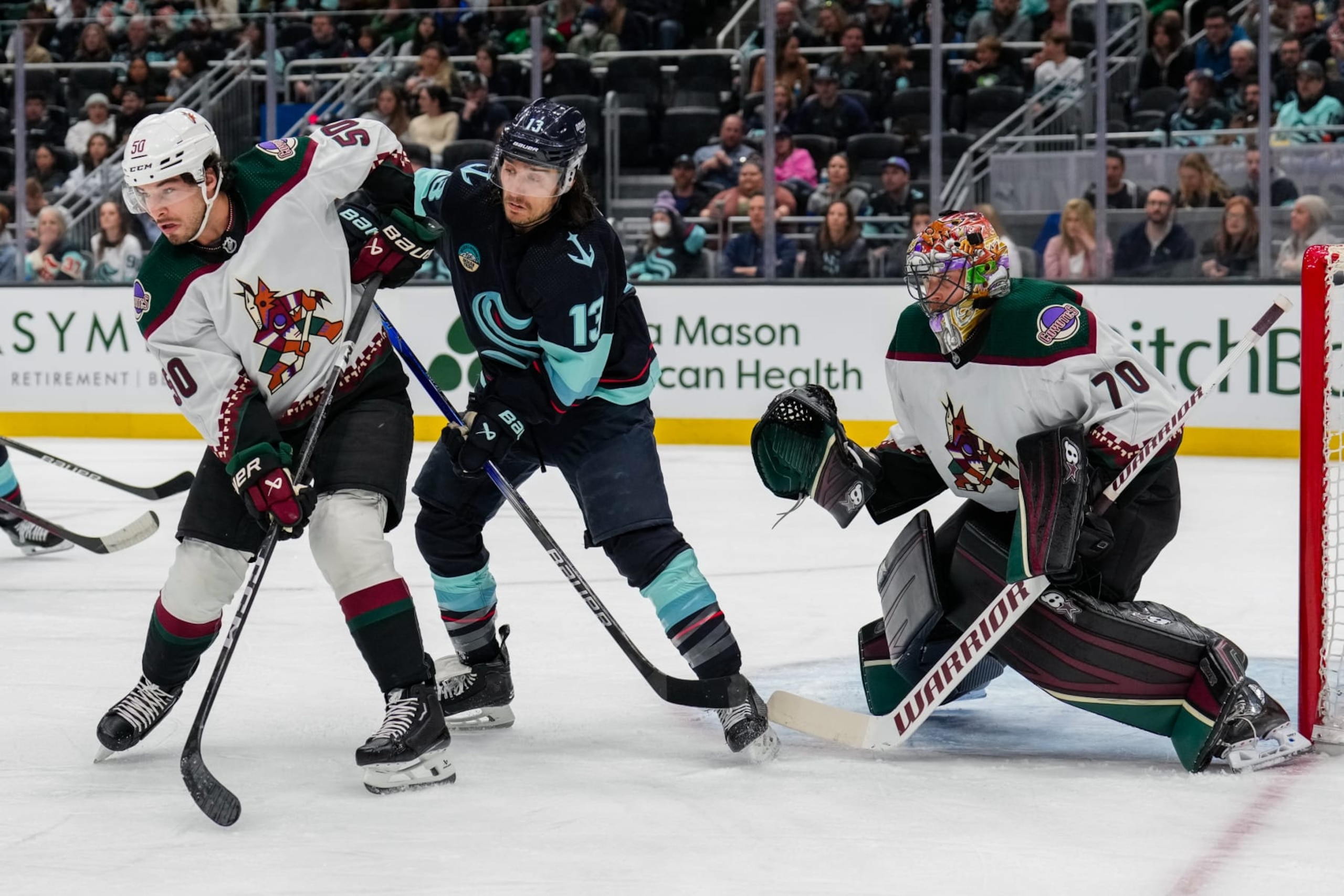 SEATTLE, WASHINGTON - APRIL 09: Sean Durzi #50 of the Arizona Coyotes and Brandon Tanev #13 of the Seattle Kraken battle for position during the first period of a game against the OPPONENT at Climate Pledge Arena on April 9, 2024 in Seattle, Washington. (Photo by Christopher Mast/NHLI via Getty Images) SEATTLE, WASHINGTON - APRIL 09: Sean Durzi #50 of the Arizona Coyotes and Brandon Tanev #13 of the Seattle Kraken battle for position during the first period of a game against the OPPONENT at Climate Pledge Arena on April 9, 2024 in Seattle, Washington. (Photo by Christopher Mast/NHLI via Getty Images)