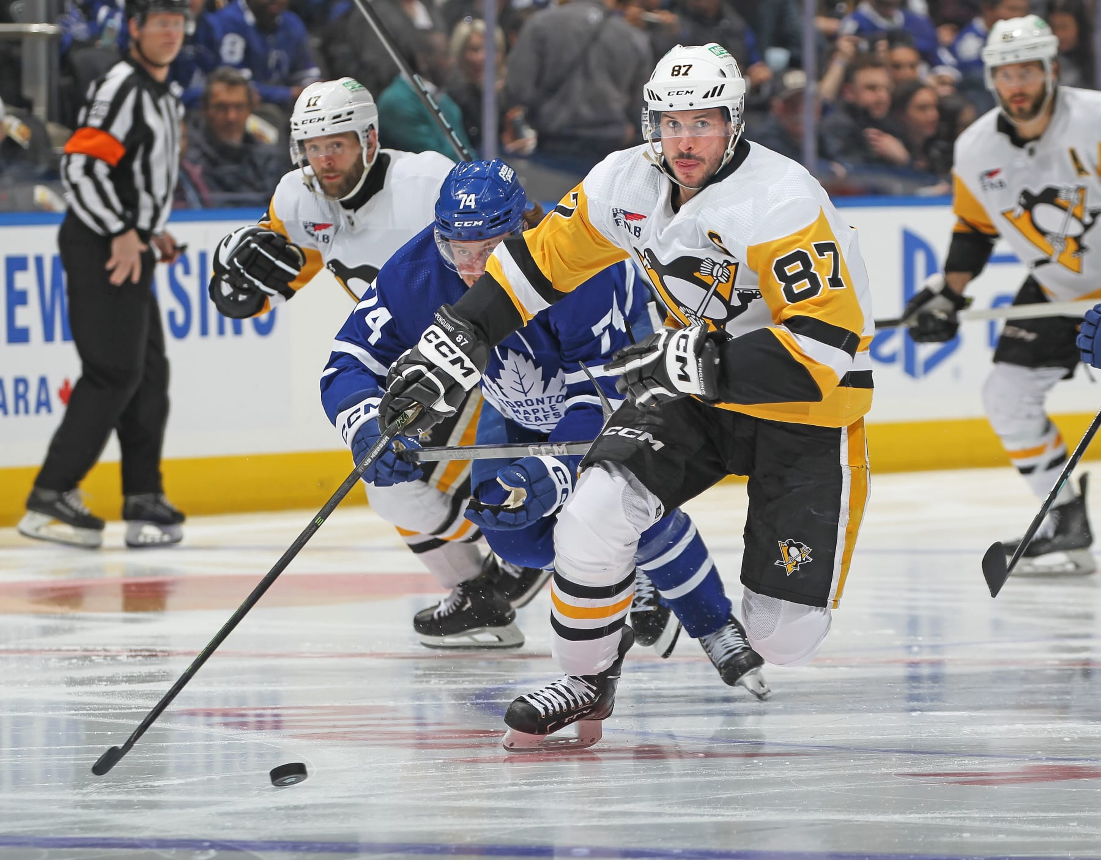 TORONTO, CANADA - APRIL 8:  Sidney Crosby #87 of the Pittsburgh Penguins skates the puck against the Toronto Maple Leafs during the third period at Scotiabank Arena on April 8, 2024 in Toronto, Ontario, Canada. The Maple Leafs defeated the Penguins 3-2 in overtime. (Photo by Claus Andersen/Getty Images)