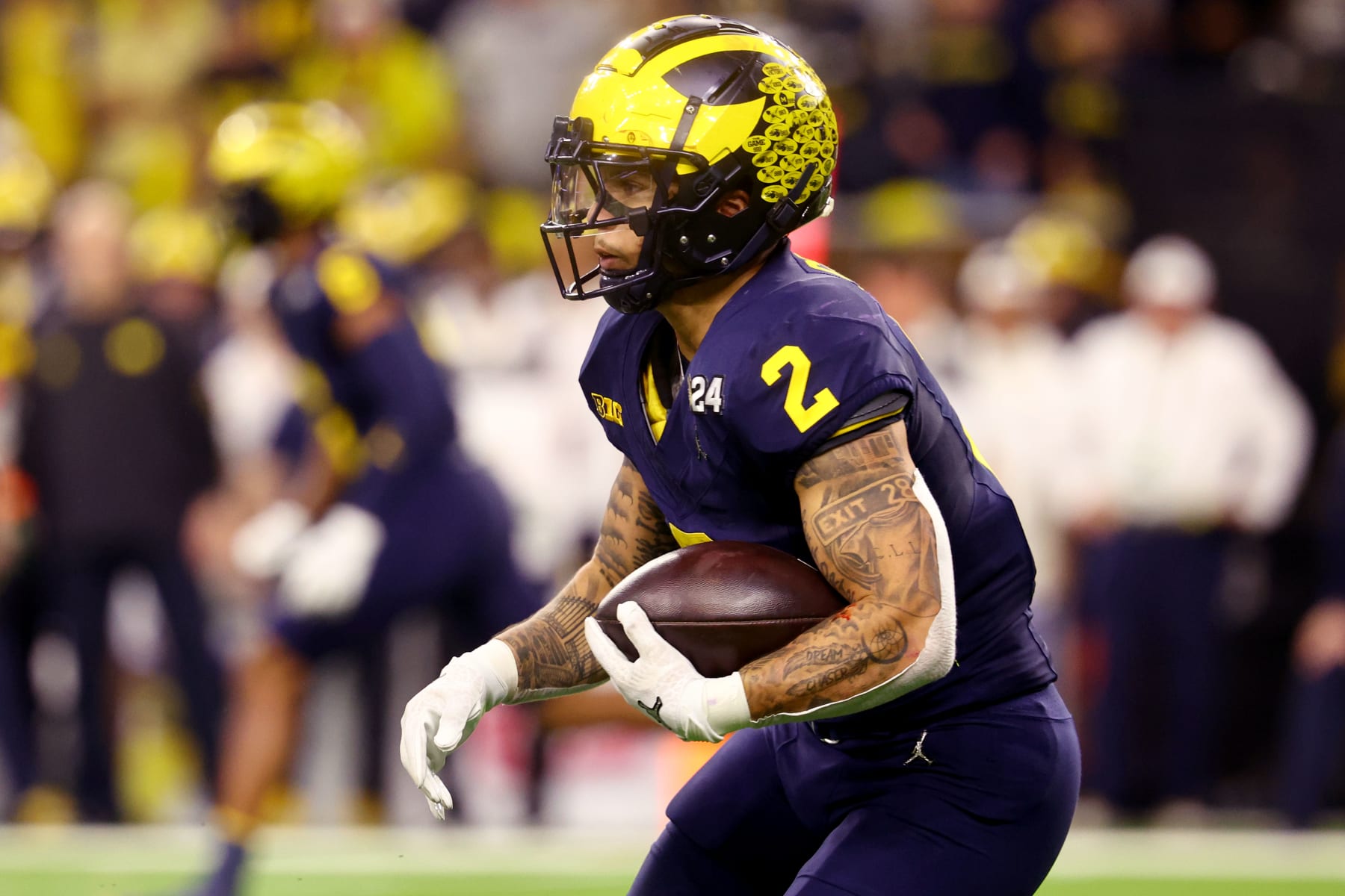 HOUSTON, TEXAS - JANUARY 8: Blake Corum #2 of the Michigan Wolverines rushes against the Washington Huskies during the 2024 CFP National Championship game at NRG Stadium on January 8, 2024 in Houston, Texas. (Photo by Jamie Schwaberow/Getty Images)