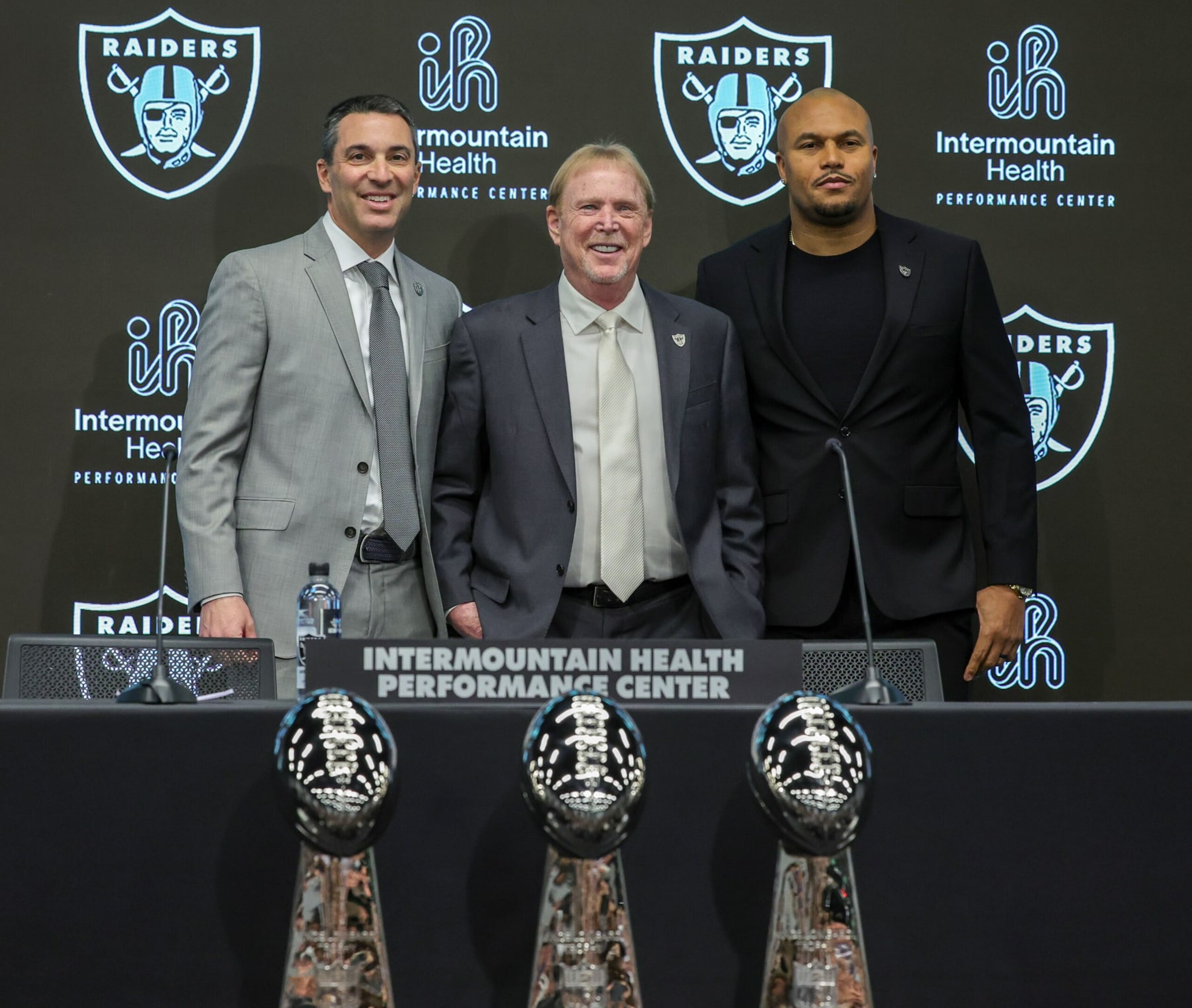 HENDERSON, NEVADA - JANUARY 24: Owner and managing general partner Mark Davis (C) of the Las Vegas Raiders poses for photos with Tom Telesco (L) and Antonio Pierce (R) during a news conference introducing Telesco as the general manager and Pierce as the head coach of the Raiders at the Las Vegas Raiders Headquarters/Intermountain Healthcare Performance Center on January 24, 2024 in Henderson, Nevada. (Photo by Ethan Miller/Getty Images)