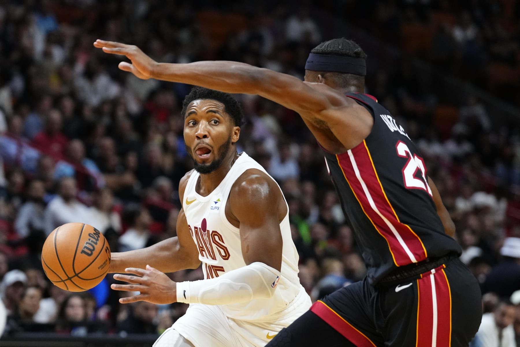 MIAMI, FLORIDA - DECEMBER 08: Donovan Mitchell #45 of the Cleveland Cavaliers controls the ball against Jimmy Butler #22 of the Miami Heat during the second quarter at Kaseya Center on December 08, 2023 in Miami, Florida. NOTE TO USER: User expressly acknowledges and agrees that, by downloading and or using this photograph, User is consenting to the terms and conditions of the Getty Images License Agreement. (Photo by Rich Storry/Getty Images)