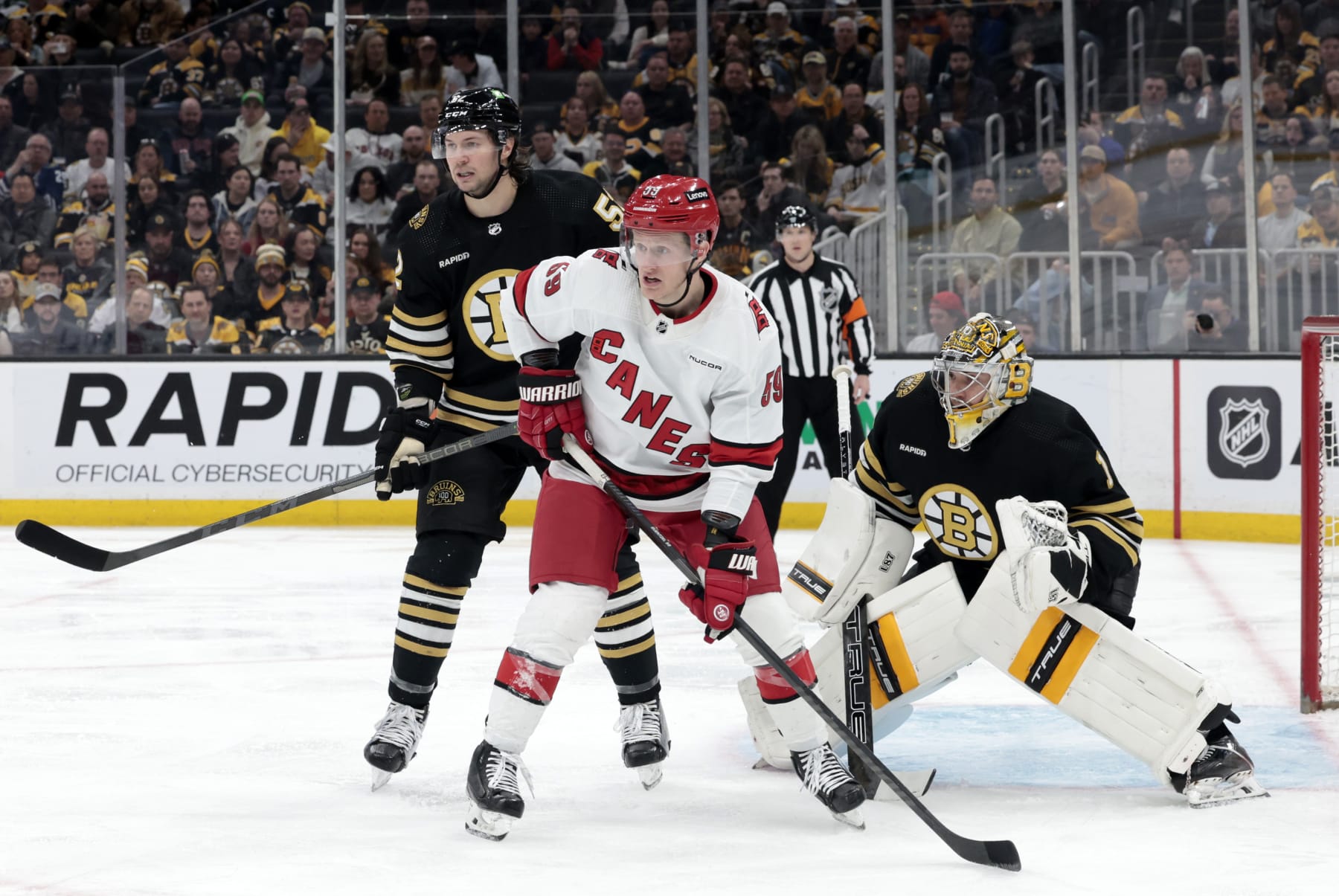 BOSTON, MA - APRIL 09: Carolina Hurricanes left wing Jake Guentzel (59) sets up in front of Boston Bruins goalie Jeremy Swayman (1) on the power play during a game between the Boston Bruins and the Carolina Hurricanes on April 9, 2024, at TD Garden in Boston, Massachusetts. (Photo by Fred Kfoury III/Icon Sportswire via Getty Images)