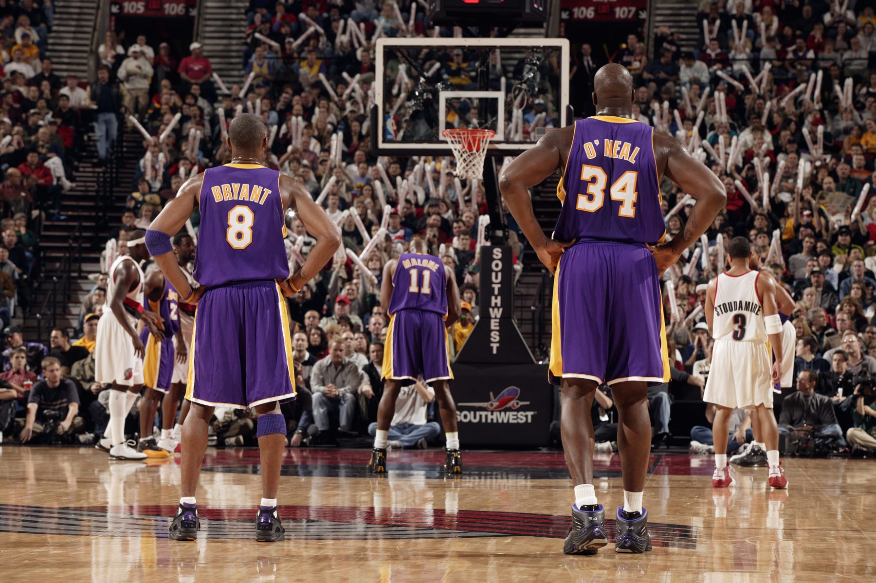 PORTLAND, OR - DECEMBER 13:  Karl Malone #11 of the Los Angeles Lakers shoots a free throw as teammates Kobe Bryant #8 and Shaquille O'Neal #34 look on during the game against the Portland Trail Blazers on December 13, 2003 at the Rose Garden in Portland, Oregon.  The Trail Blazers won 112-108.  NOTE TO USER: User expressly acknowledges and agrees that, by downloading and/or using this Photograph, User is consenting to the terms and conditions of the Getty Images License Agreement. (Photo by Sam Forencich/NBAE via Getty Images)