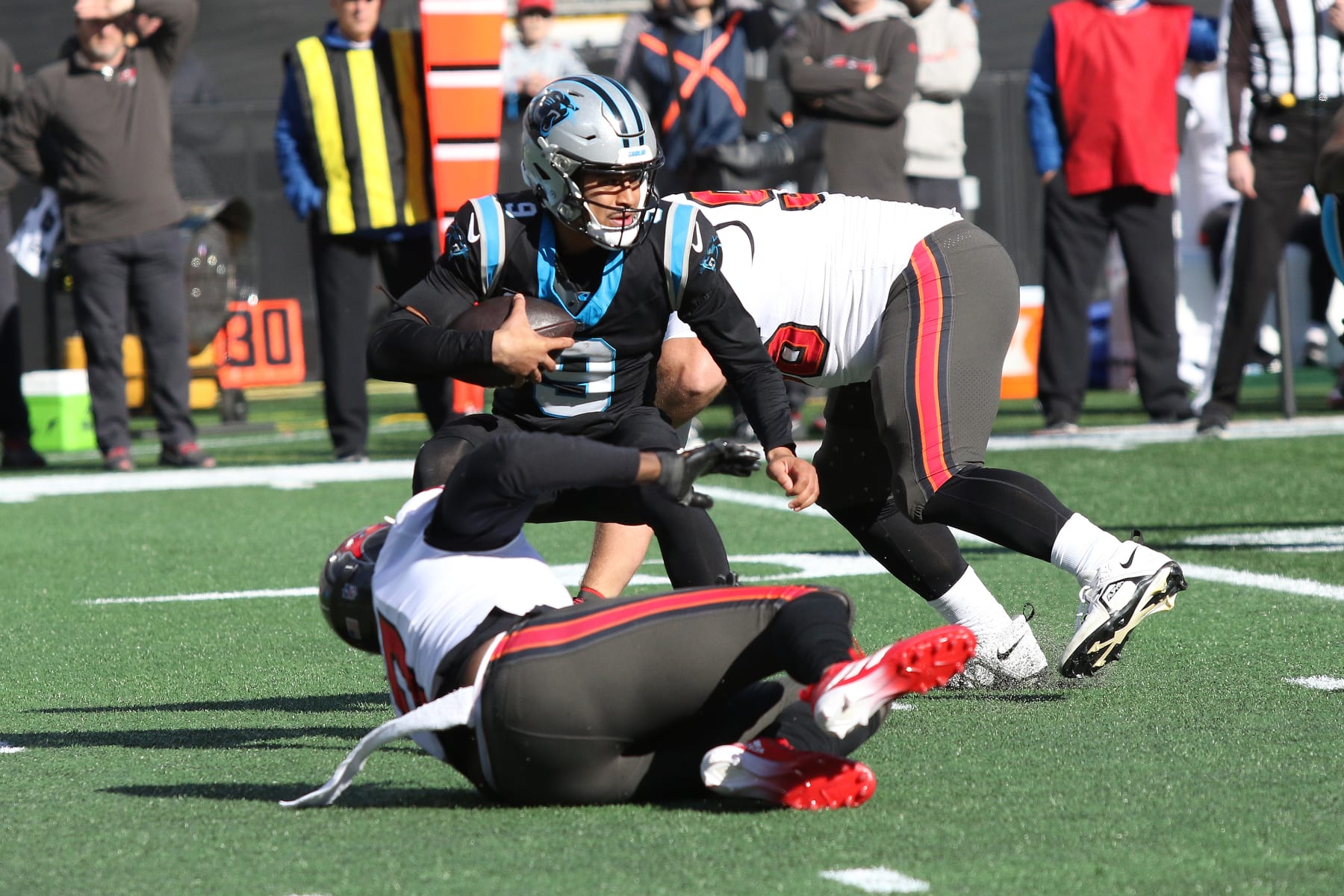 CHARLOTTE, NC - JANUARY 07: Carolina Panthers quarterback Bryce Young (9) is sacked, but there was defensive holding on the play giving the Panthers a first down during an NFL football game between the Tampa Bay Buccaneers and the Carolina Panthers on January 7, 2024 at Bank of America Stadium in Charlotte, N.C. (Photo by John Byrum/Icon Sportswire via Getty Images)