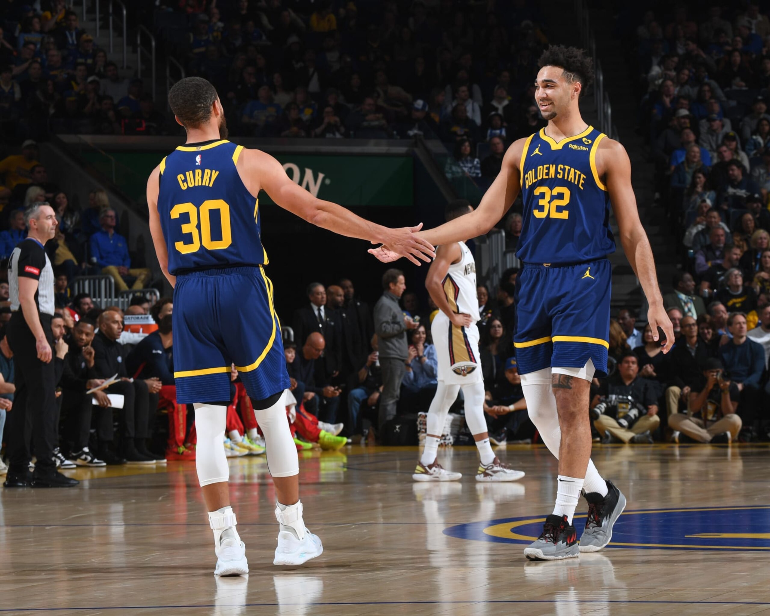 SAN FRANCISCO, CA - APRIL 12:  Stephen Curry #30 of the Golden State Warriors & Trayce Jackson-Davis #32 of the Golden State Warriors  high five during the game on April 12, 2024 at Chase Center in San Francisco, California. NOTE TO USER: User expressly acknowledges and agrees that, by downloading and or using this photograph, user is consenting to the terms and conditions of Getty Images License Agreement. Mandatory Copyright Notice: Copyright 2024 NBAE (Photo by Noah Graham/NBAE via Getty Images)