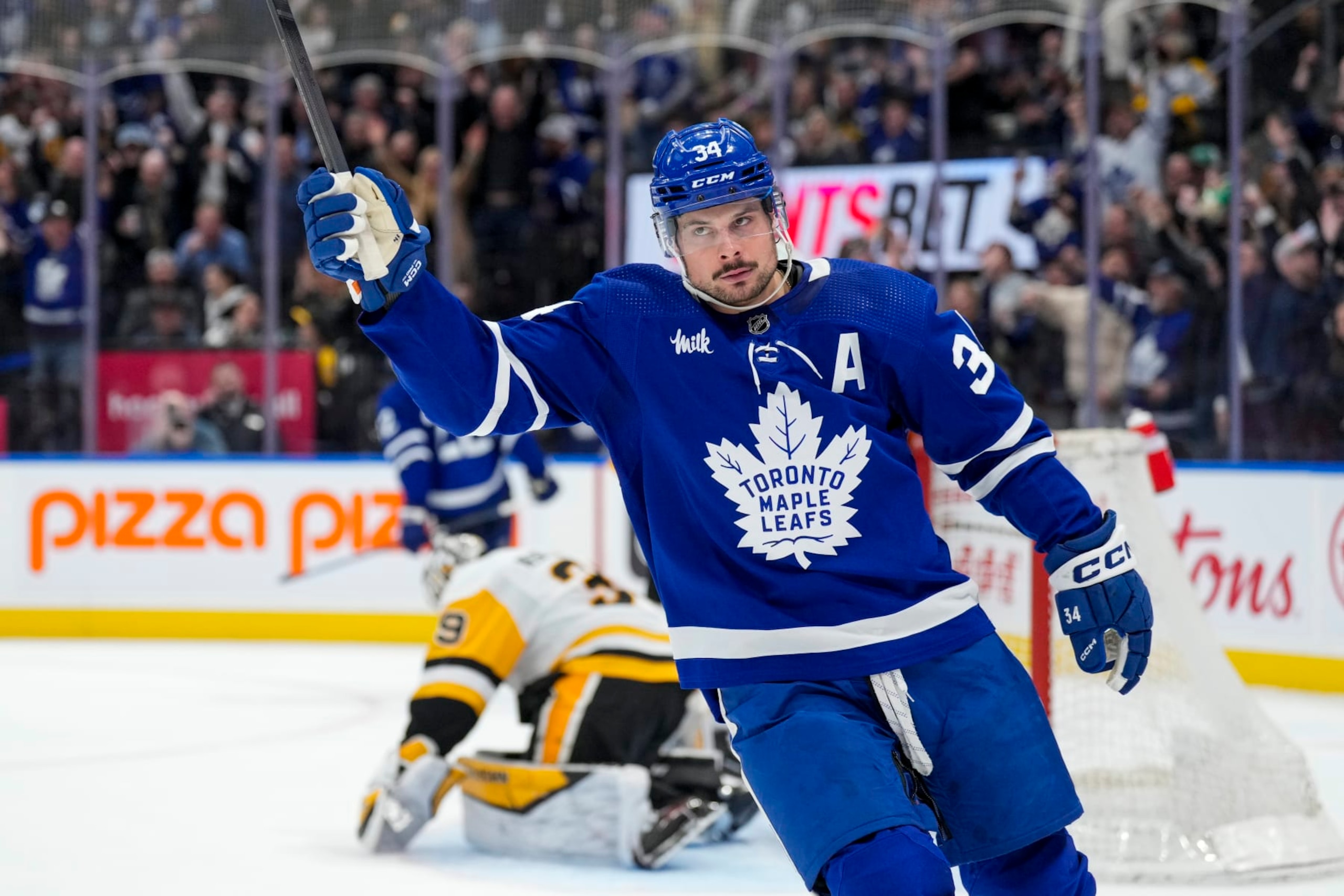 TORONTO, ON - APRIL 8: Auston Matthews #34 of the Toronto Maple Leafs celebrates after defeating the Pittsburgh Penguins during the overtime period at Scotiabank Arena on April 8, 2024 in Toronto, Ontario, Canada. (Photo by Kevin Sousa/NHLI via Getty Images)