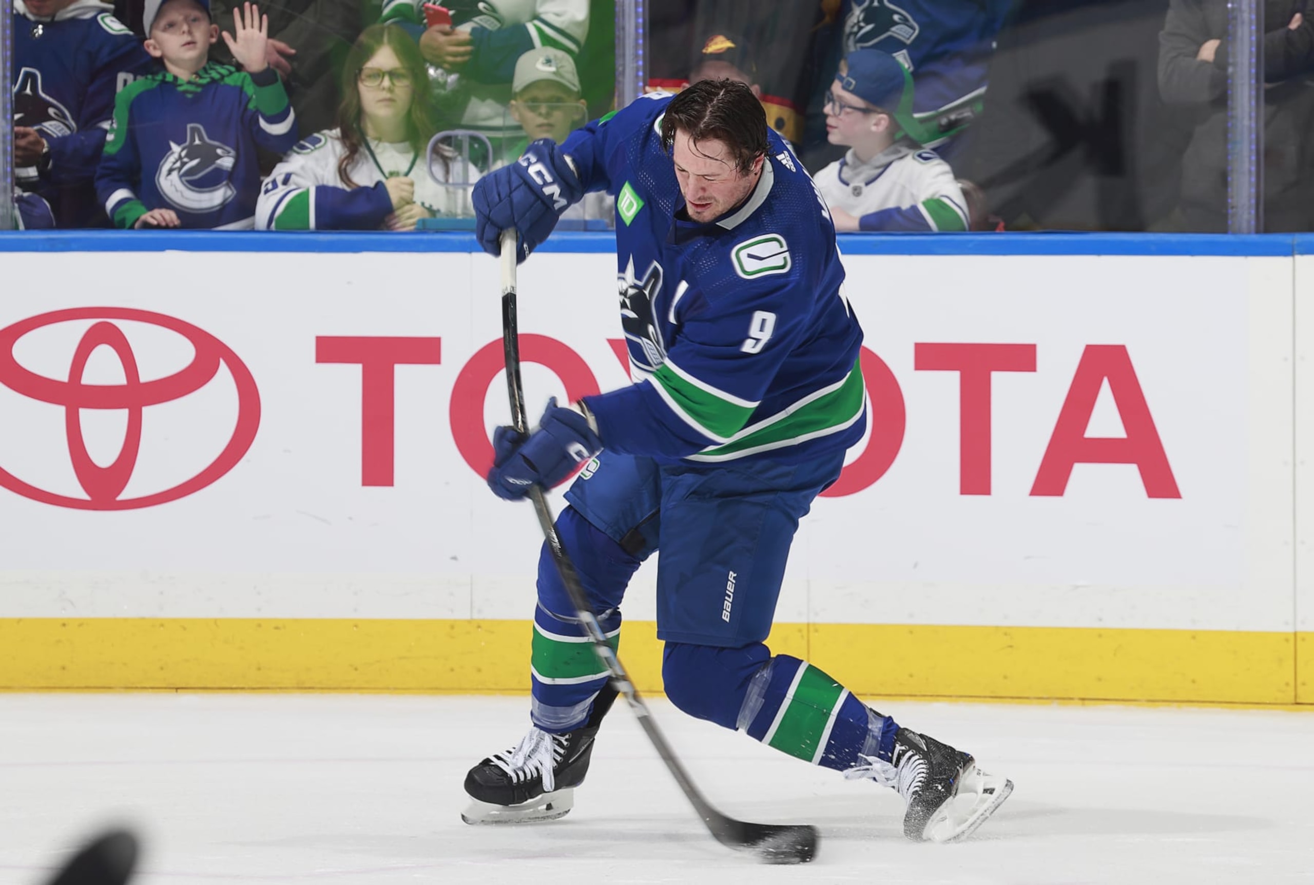 VANCOUVER, CANADA - APRIL 8: J.T. Miller #9 of the Vancouver Canucks takes a shot during warmup before their NHL game against the Vegas Golden Knights at Rogers Arena on April 8, 2024 in Vancouver, British Columbia, Canada.  (Photo by Jeff Vinnick/NHLI via Getty Images)