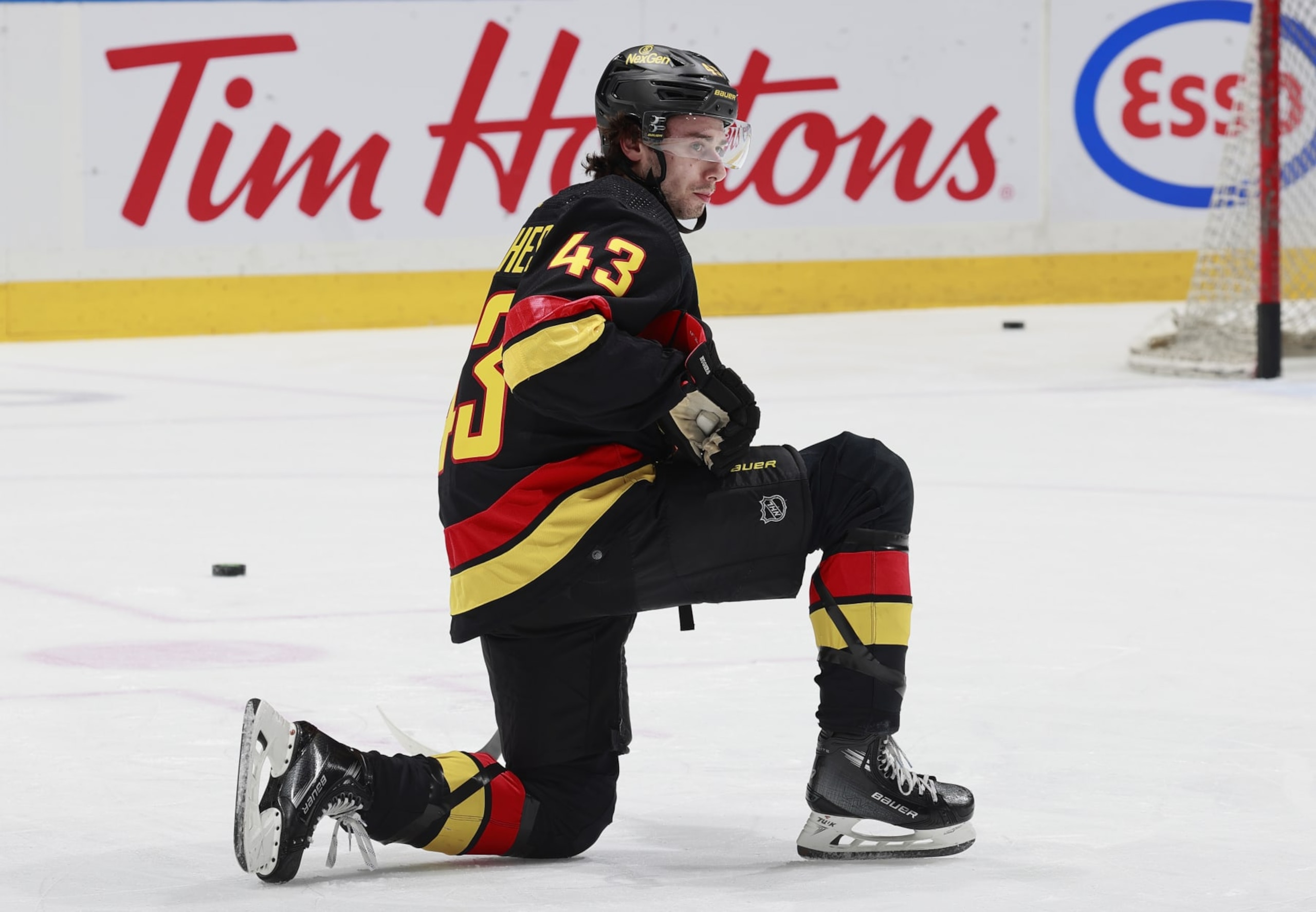 VANCOUVER, CANADA - APRIL 10: Quinn Hughes #43 of the Vancouver Canucks stretches during warmup before their NHL game against the Arizona Coyotes at Rogers Arena on April 10, 2024 in Vancouver, British Columbia, Canada.  (Photo by Jeff Vinnick/NHLI via Getty Images)