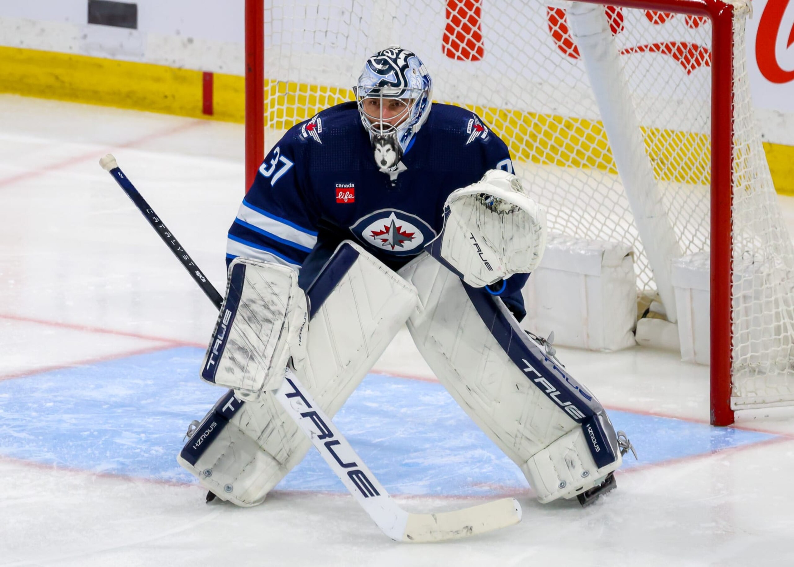 WINNIPEG, CANADA - APRIL 04: Goaltender Connor Hellebuyck #37 of the Winnipeg Jets guards the net during third period action against the Calgary Flames at Canada Life Centre on April 04, 2024 in Winnipeg, Manitoba, Canada. (Photo by Jonathan Kozub/NHLI via Getty Images)