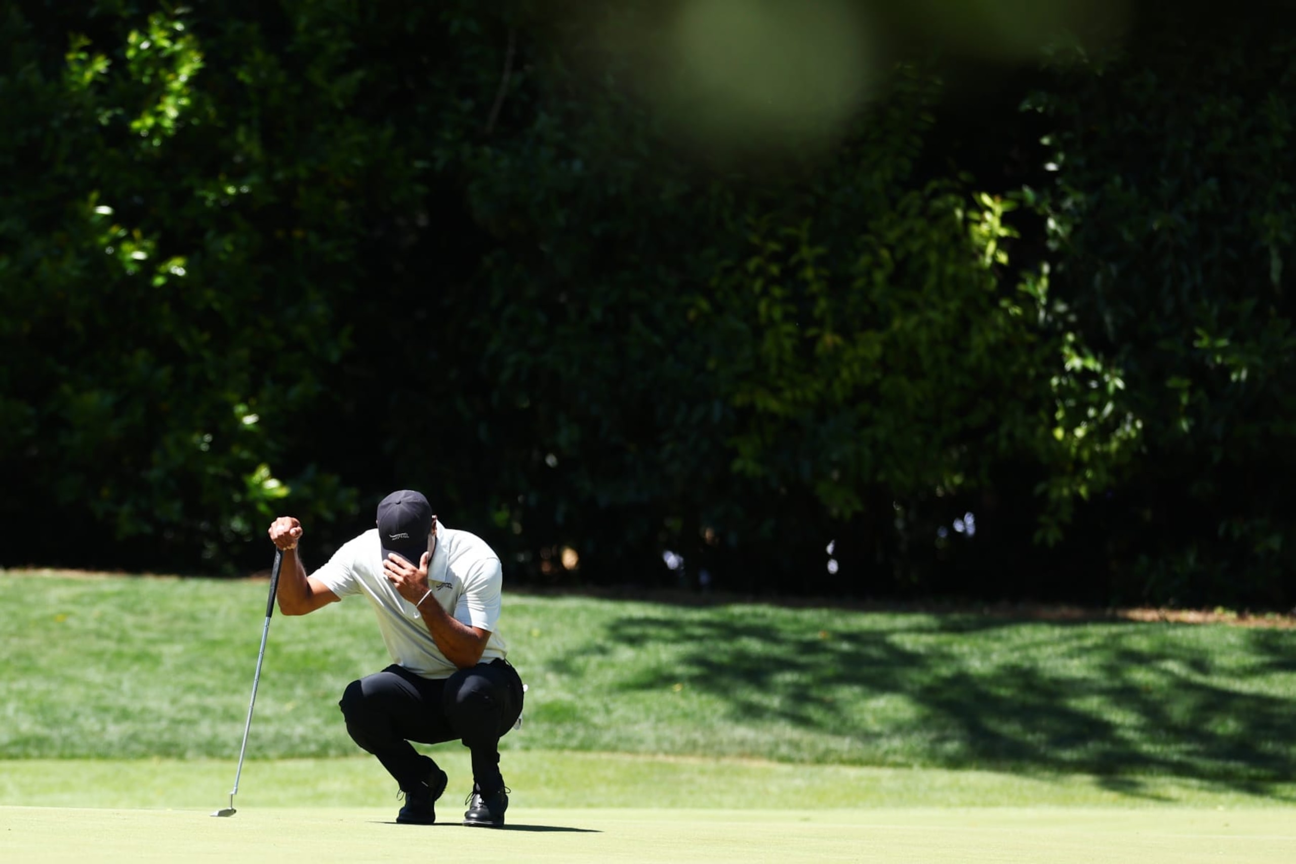 AUGUSTA, GEORGIA - APRIL 13: Tiger Woods of the United States lines up a putt on the fourth green during the third round of the 2024 Masters Tournament at Augusta National Golf Club on April 13, 2024 in Augusta, Georgia. (Photo by Maddie Meyer/Getty Images)