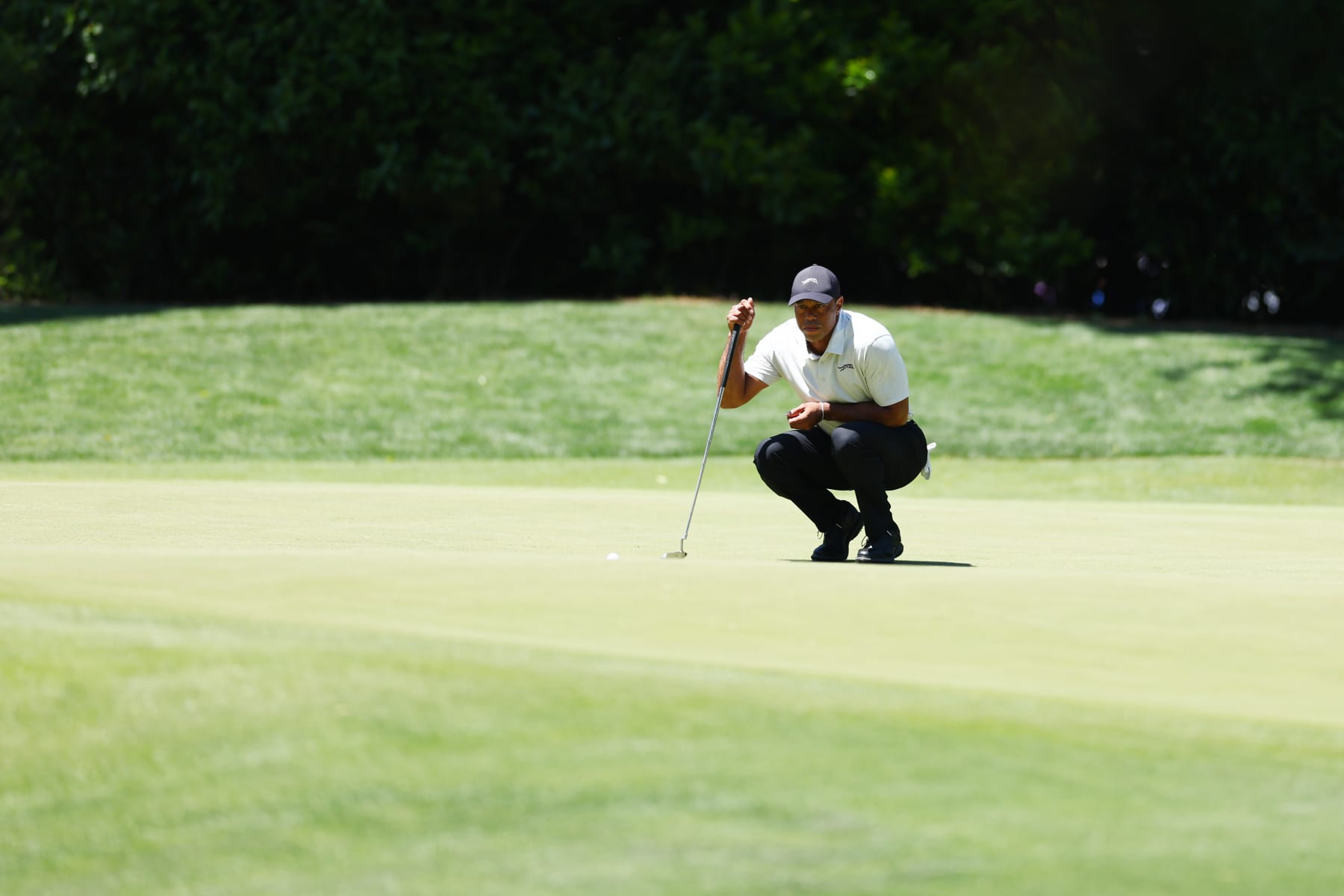 AUGUSTA, GEORGIA - APRIL 13: Tiger Woods of the United States lines up a putt on the fourth green during the third round of the 2024 Masters Tournament at Augusta National Golf Club on April 13, 2024 in Augusta, Georgia. (Photo by Maddie Meyer/Getty Images)