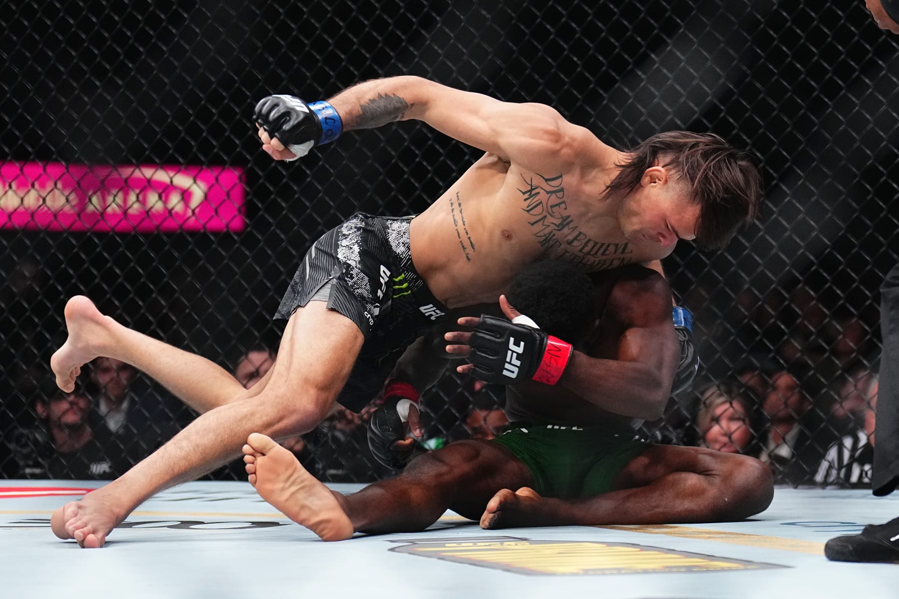 LAS VEGAS, NEVADA - APRIL 13: (L-R) Diego Lopes of Brazil punches Sodiq Yusuff of Nigeria in a featherweight fight during the UFC 300 event at T-Mobile Arena on April 13, 2024 in Las Vegas, Nevada.  (Photo by Chris Unger/Zuffa LLC via Getty Images)