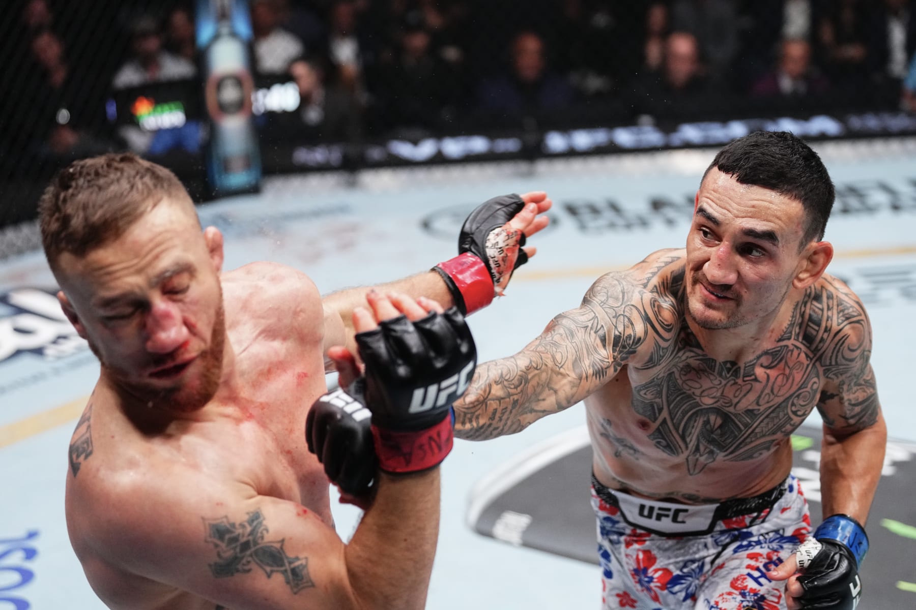 LAS VEGAS, NEVADA - APRIL 13: (R-L) Max Holloway punches Justin Gaethje in a lightweight fight during the UFC 300 event at T-Mobile Arena on April 13, 2024 in Las Vegas, Nevada.  (Photo by Jeff Bottari/Zuffa LLC via Getty Images)
