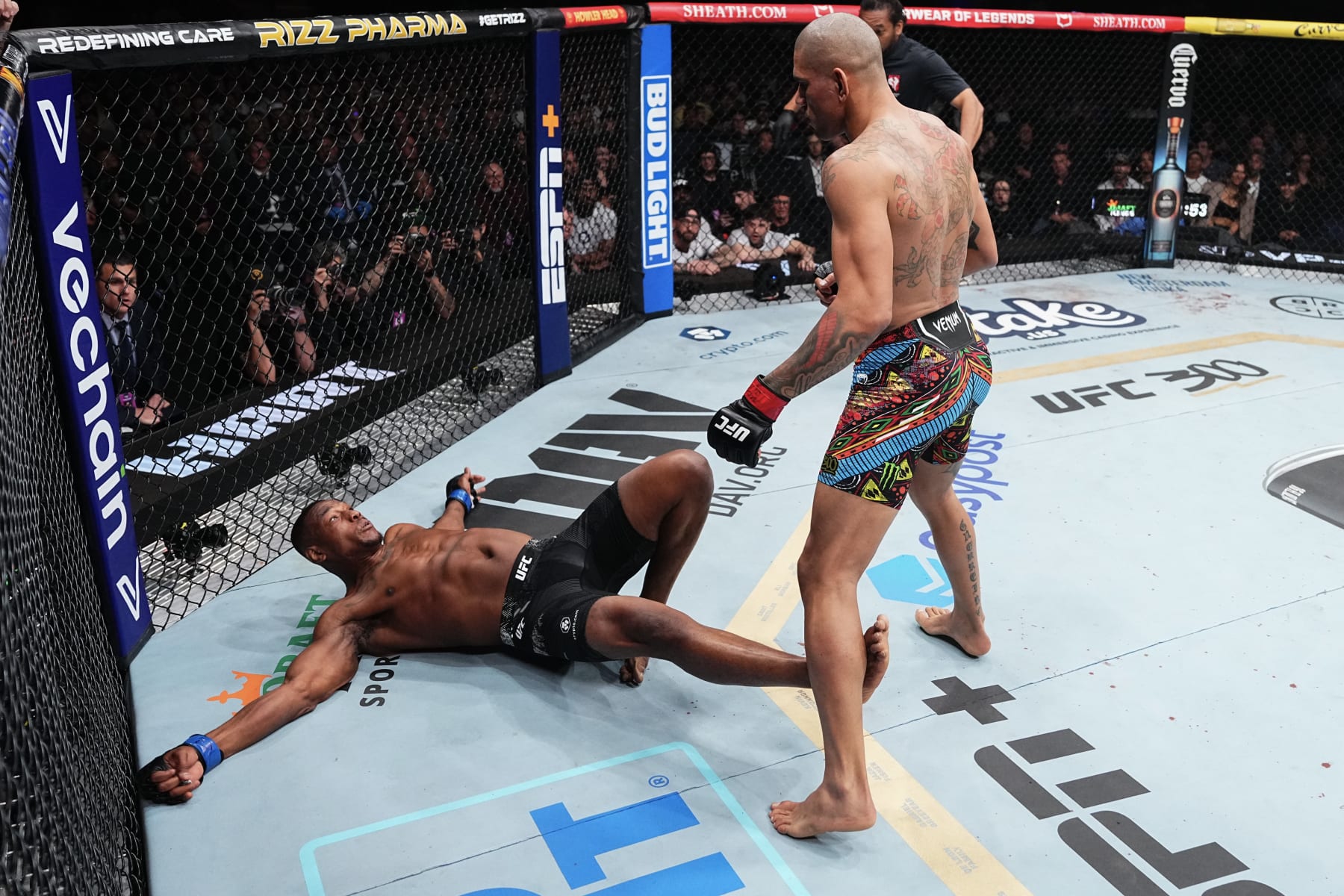 LAS VEGAS, NEVADA - APRIL 13: (R-L) Alex Pereira of Brazil knocks down Jamahal Hill in the UFC light heavyweight championship fight during the UFC 300 event at T-Mobile Arena on April 13, 2024 in Las Vegas, Nevada.  (Photo by Jeff Bottari/Zuffa LLC via Getty Images)