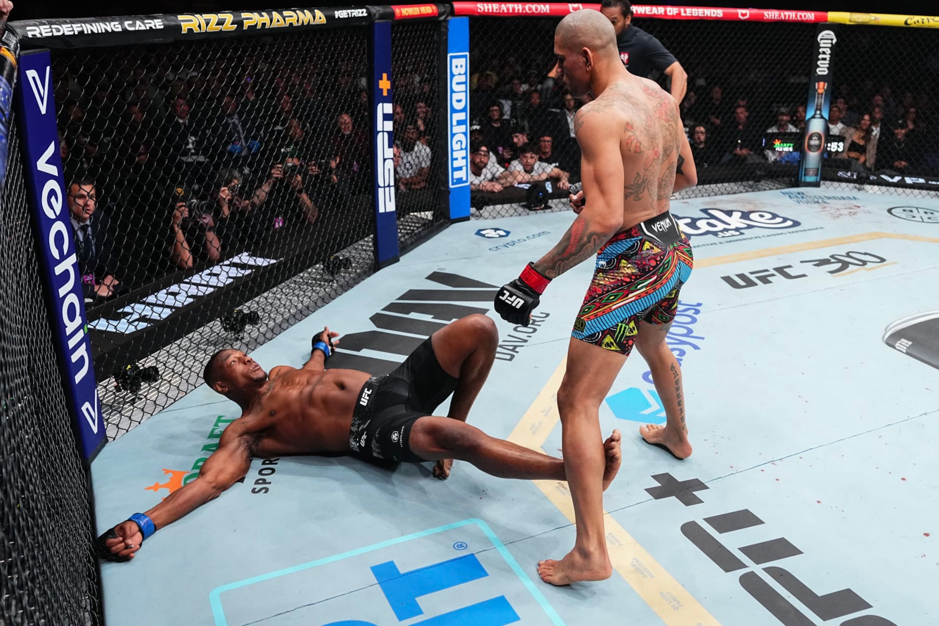 LAS VEGAS, NEVADA - APRIL 13: (R-L) Alex Pereira of Brazil knocks down Jamahal Hill in the UFC light heavyweight championship fight during the UFC 300 event at T-Mobile Arena on April 13, 2024 in Las Vegas, Nevada.  (Photo by Jeff Bottari/Zuffa LLC via Getty Images)