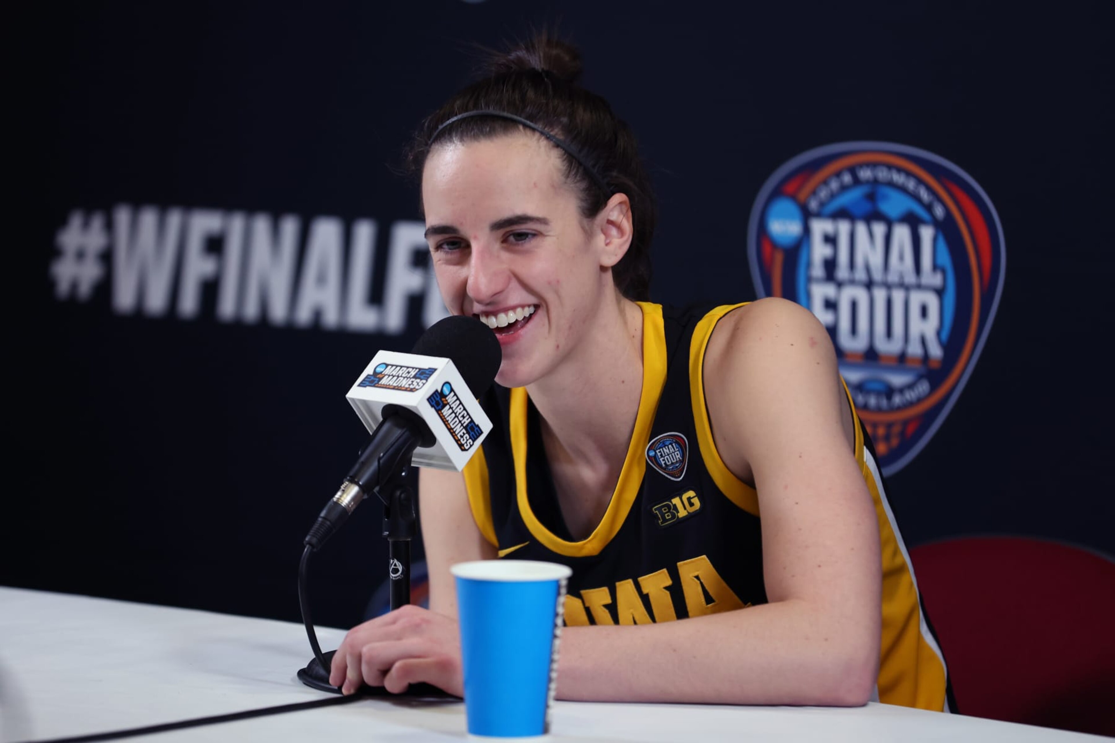 CLEVELAND, OHIO - APRIL 07: Caitlin Clark #22 of the Iowa Hawkeyes talks with the media after losing to the South Carolina Gamecocks in the 2024 NCAA Women's Basketball Tournament National Championship at Rocket Mortgage FieldHouse on April 07, 2024 in Cleveland, Ohio. South Carolina beat Iowa 87-75. (Photo by Steph Chambers/Getty Images) CLEVELAND, OHIO - APRIL 07: Caitlin Clark #22 of the Iowa Hawkeyes talks with the media after losing to the South Carolina Gamecocks in the 2024 NCAA Women's Basketball Tournament National Championship at Rocket Mortgage FieldHouse on April 07, 2024 in Cleveland, Ohio. South Carolina beat Iowa 87-75. (Photo by Steph Chambers/Getty Images)