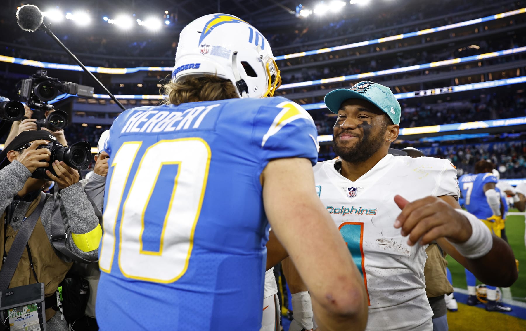 INGLEWOOD, CALIFORNIA - DECEMBER 11: Justin Herbert #10 of the Los Angeles Chargers hugs Tua Tagovailoa #1 of the Miami Dolphins during a game  at SoFi Stadium on December 11, 2022 in Inglewood, California. (Photo by Ronald Martinez/Getty Images)
