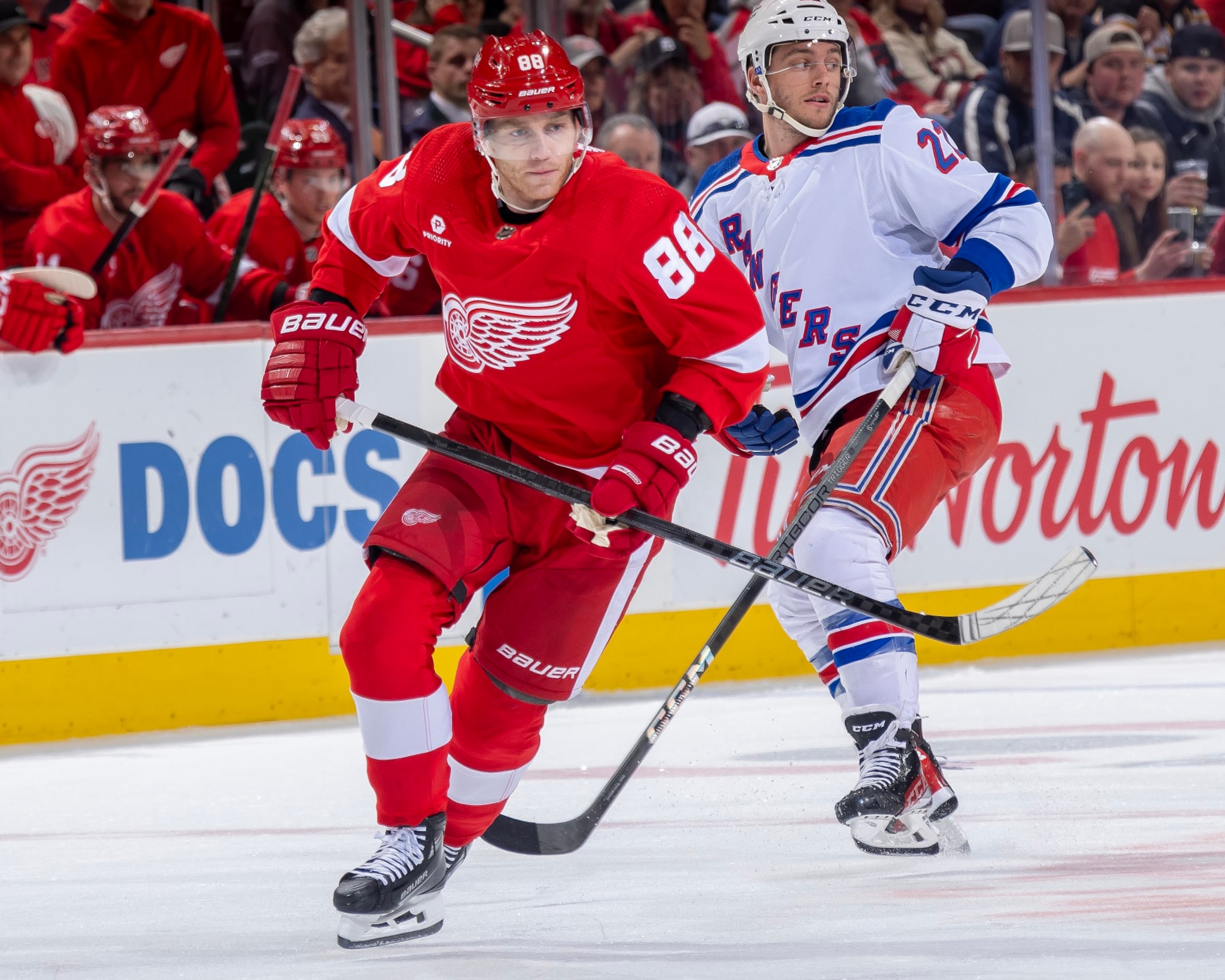 DETROIT, MI - APRIL 05: Patrick Kane #88 of the Detroit Red Wings follows the play in front of Jonny Brodzinski #22 of the New York Rangers during the first period at Little Caesars Arena on April 5, 2024 in Detroit, Michigan. New York defeated Detroit 4-3. (Photo by Dave Reginek/NHLI via Getty Images)