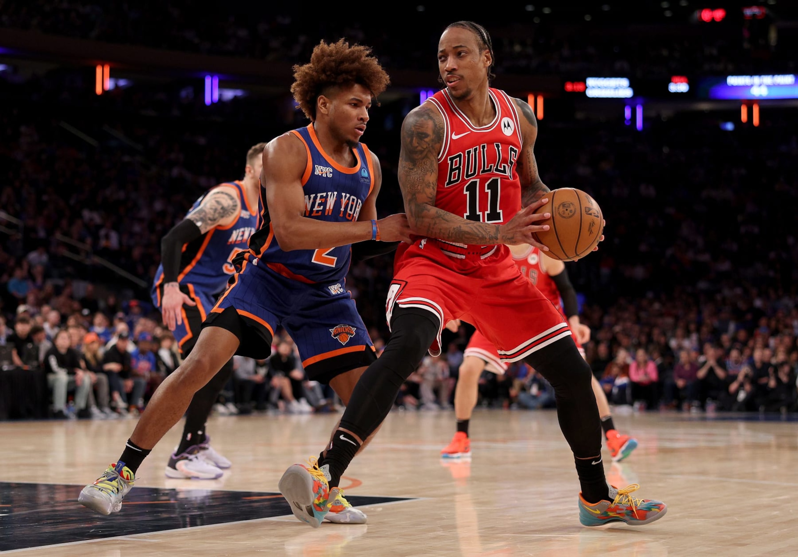 NEW YORK, NEW YORK - APRIL 14: DeMar DeRozan #11 of the Chicago Bulls heads for the net as Miles McBride #2 of the New York Knicks defends during the second half at Madison Square Garden on April 14, 2024 in New York City. The New York Knicks defeated the Chicago Bulls 120-119 in OT. NOTE TO USER: User expressly acknowledges and agrees that, by downloading and or using this photograph, User is consenting to the terms and conditions of the Getty Images License Agreement. (Photo by Elsa/Getty Images)