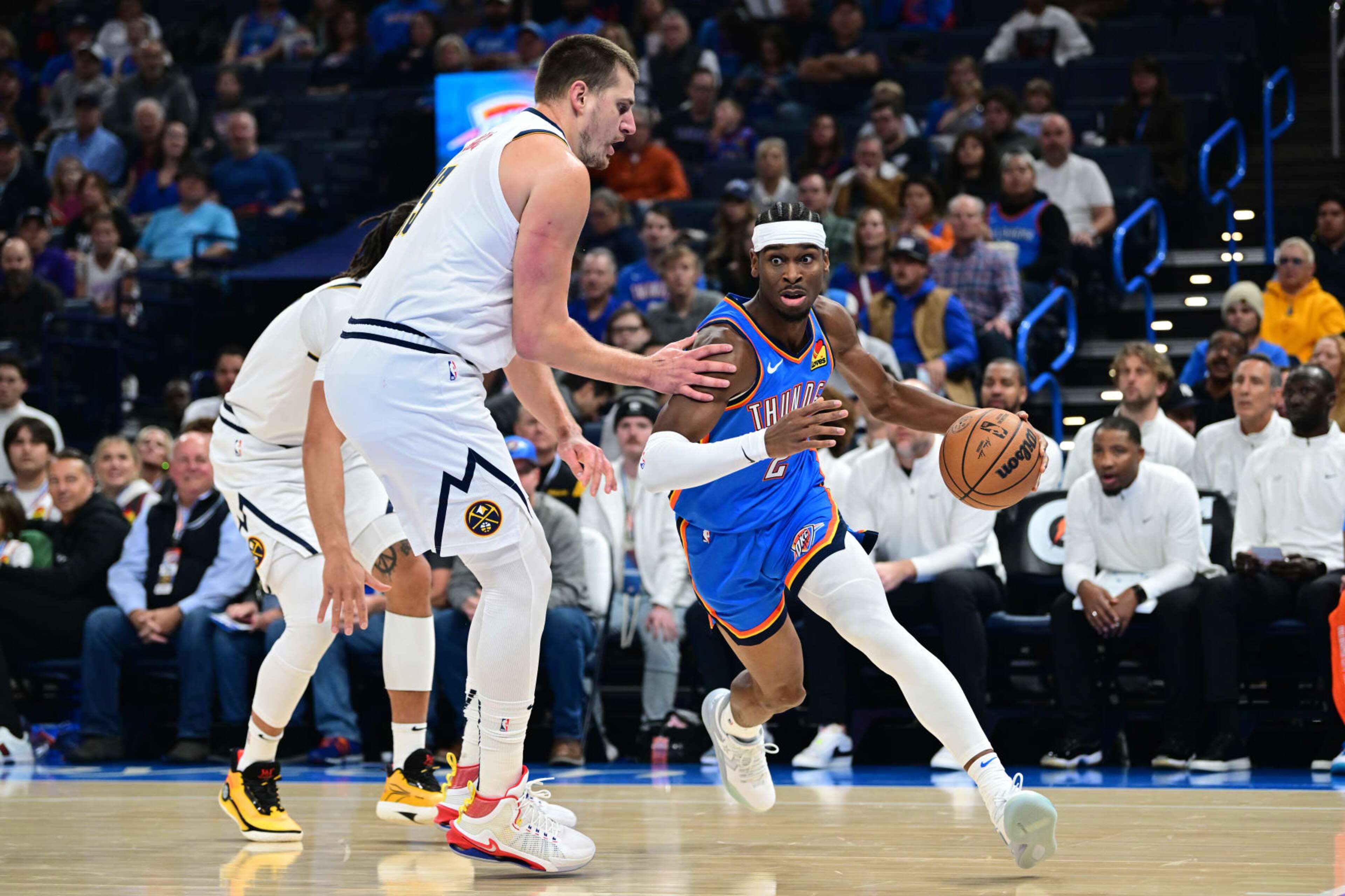 OKLAHOMA CITY, OKLAHOMA - OCTOBER 29: Shai Gilgeous-Alexander #2 of the Oklahoma City Thunder attempts to drive past Nikola Jokic #15 of the Denver Nuggets during the first quarter of a game at Paycom Center on October 29, 2023 in Oklahoma City, Oklahoma. NOTE TO USER: User expressly acknowledges and agrees that, by downloading and or using this photograph, User is consenting to the terms and conditions of the Getty Images License Agreement. (Photo by Joshua Gateley/Getty Images) OKLAHOMA CITY, OKLAHOMA - OCTOBER 29: Shai Gilgeous-Alexander #2 of the Oklahoma City Thunder attempts to drive past Nikola Jokic #15 of the Denver Nuggets during the first quarter of a game at Paycom Center on October 29, 2023 in Oklahoma City, Oklahoma. NOTE TO USER: User expressly acknowledges and agrees that, by downloading and or using this photograph, User is consenting to the terms and conditions of the Getty Images License Agreement. (Photo by Joshua Gateley/Getty Images)