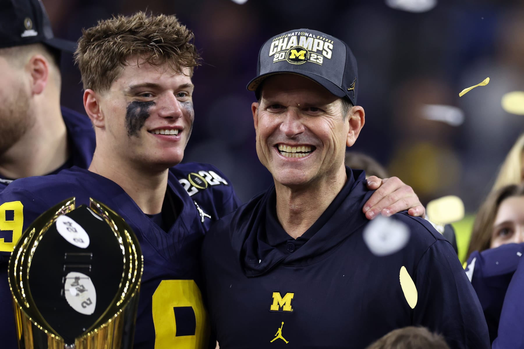 HOUSTON, TEXAS - JANUARY 08: J.J. McCarthy #9 and head coach Jim Harbaugh of the Michigan Wolverines celebrate after defeating the Washington Huskies during the 2024 CFP National Championship game at NRG Stadium on January 08, 2024 in Houston, Texas. Michigan defeated Washington 34-13. (Photo by Maddie Meyer/Getty Images)
