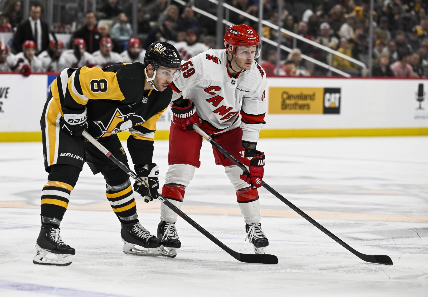 Pittsburgh Penguins left wing Michael Bunting (left) and Carolina Hurricanes left wing Jake Guentzel