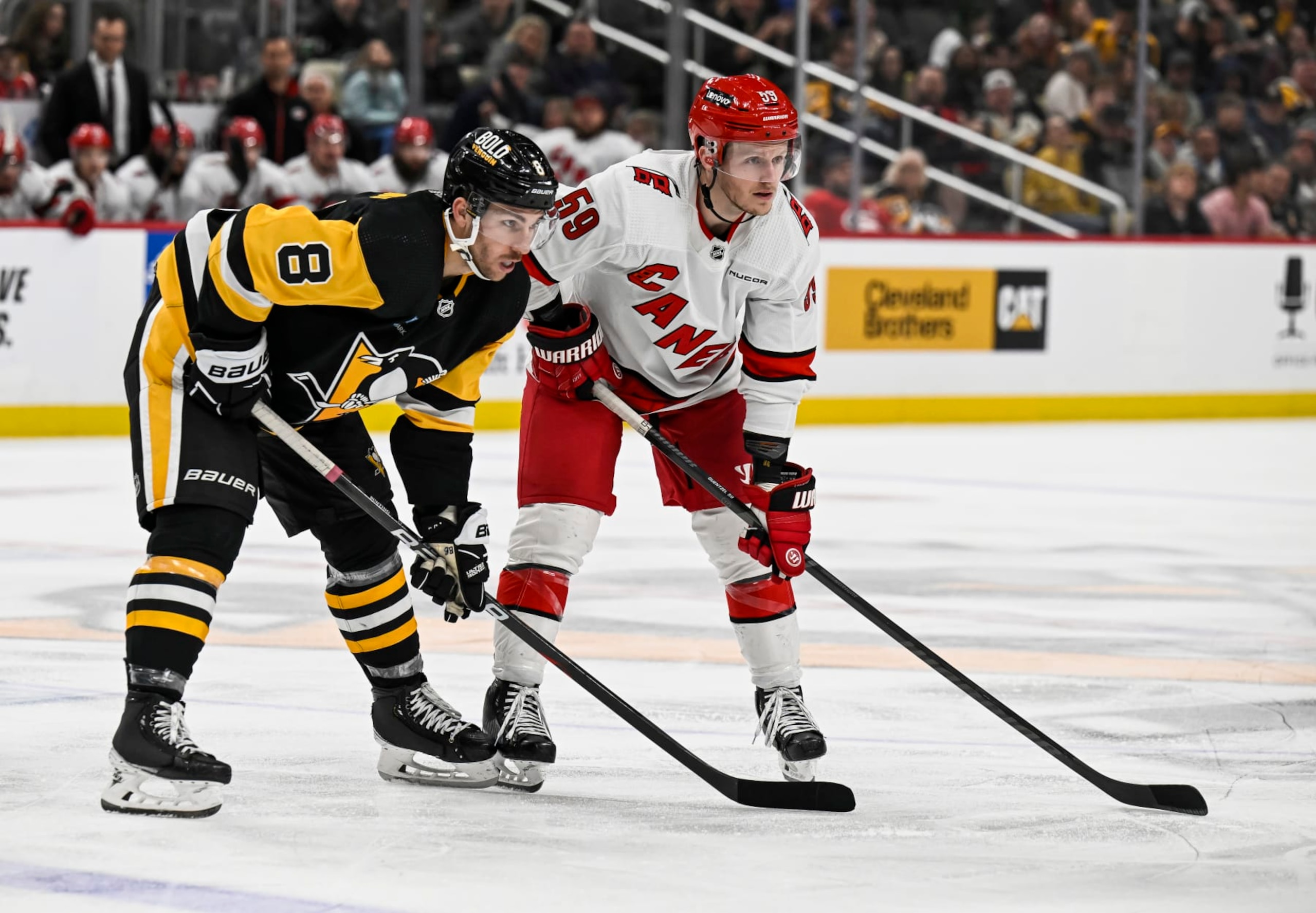 Pittsburgh Penguins left wing Michael Bunting (left) and Carolina Hurricanes left wing Jake Guentzel