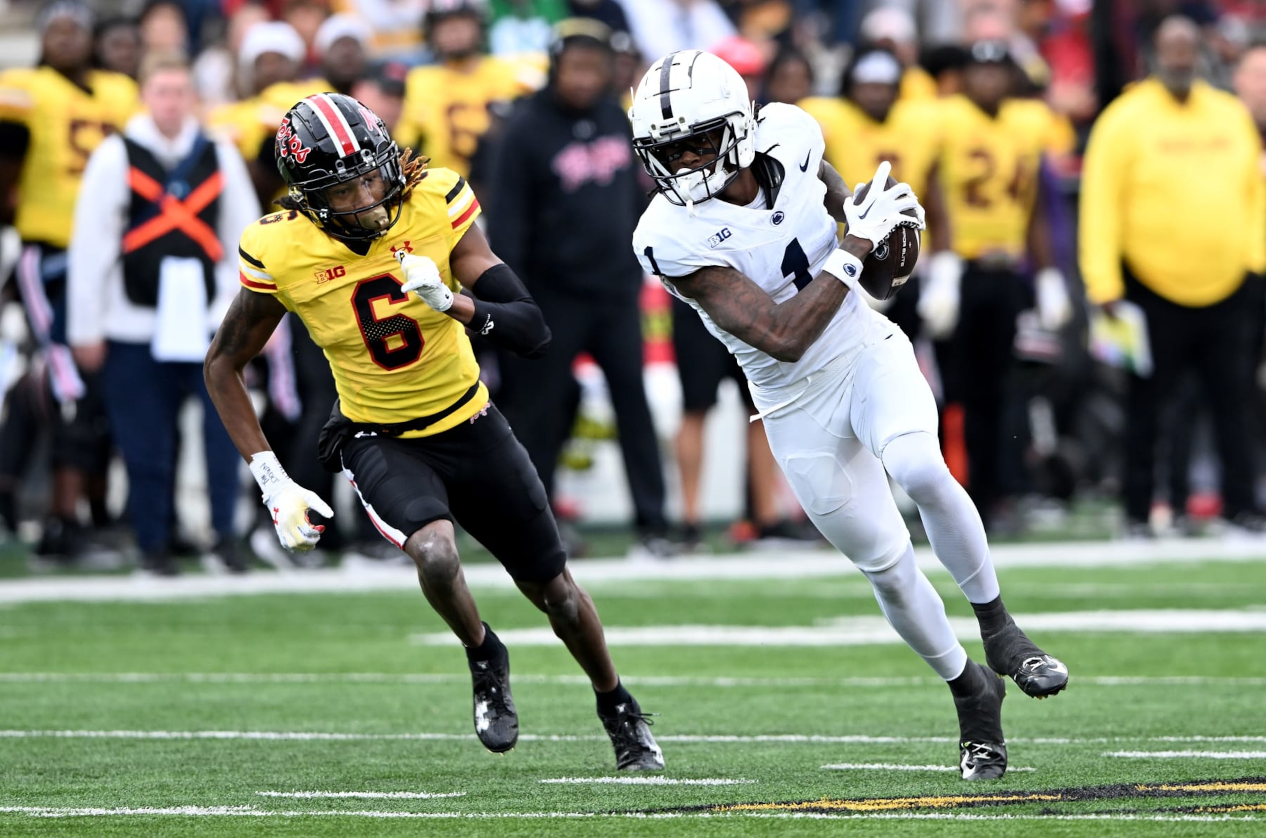 COLLEGE PARK, MARYLAND - NOVEMBER 04: KeAndre Lambert-Smith #1 of the Penn State Nittany Lions runs with the ball after a catch against Corey Coley Jr. #6 of the Maryland Terrapins at SECU Stadium on November 04, 2023 in College Park, Maryland. (Photo by G Fiume/Getty Images)